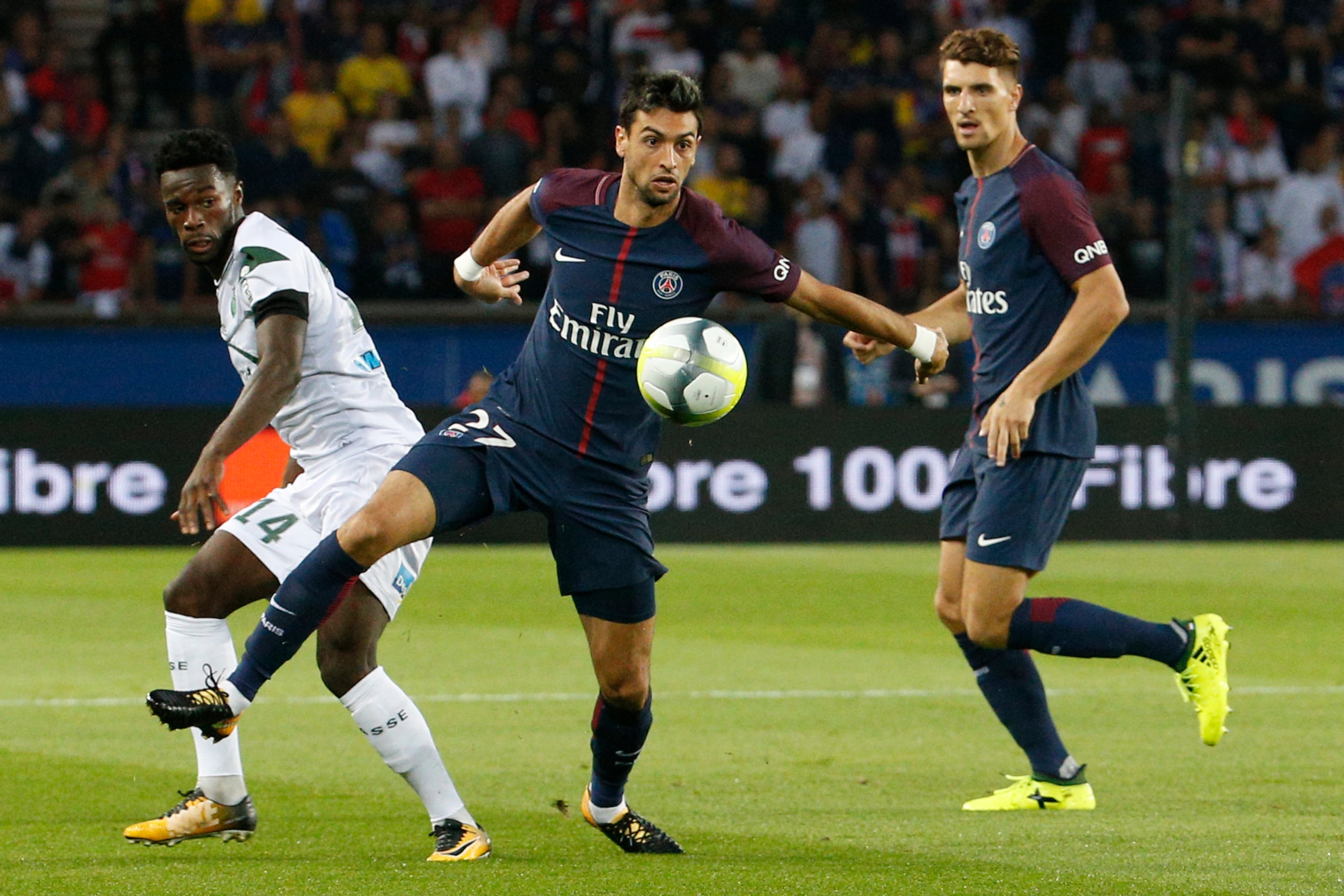 Paris Saint-Germain's Argentinian midfielder Javier Pastore (C) vies for the ball with Saint-Etienne's French forward Jonathan Bamba (L)   during the French L1 football match between Paris Saint-Germain (PSG) and Saint-Etienne (ASSE) on August 25, 2017, a