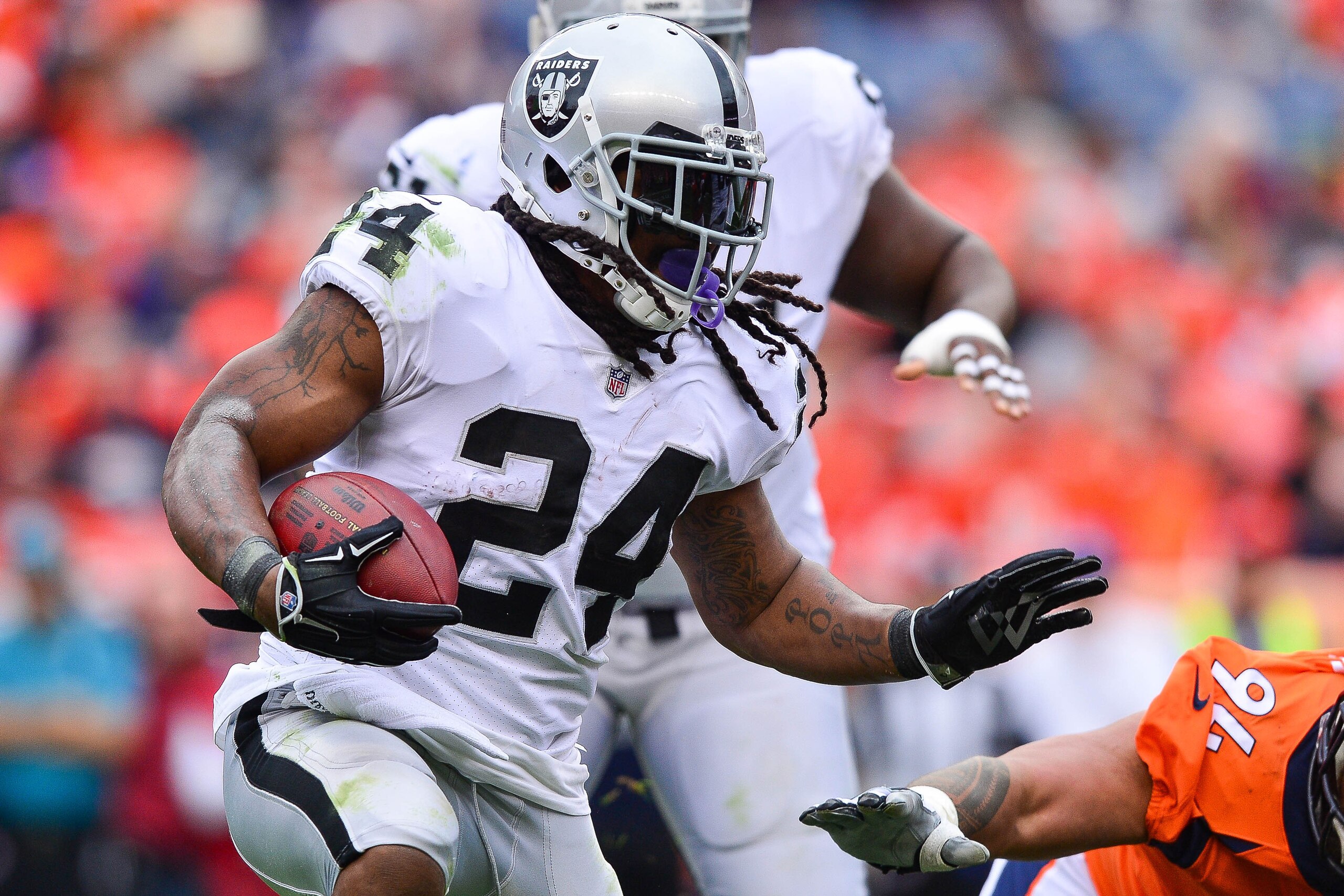 DENVER, CO - OCTOBER 1:  Running back Marshawn Lynch #24 of the Oakland Raiders carries the ball against the Denver Broncos int he third quarter of a game at Sports Authority Field at Mile High on October 1, 2017 in Denver, Colorado. (Photo by Dustin Brad