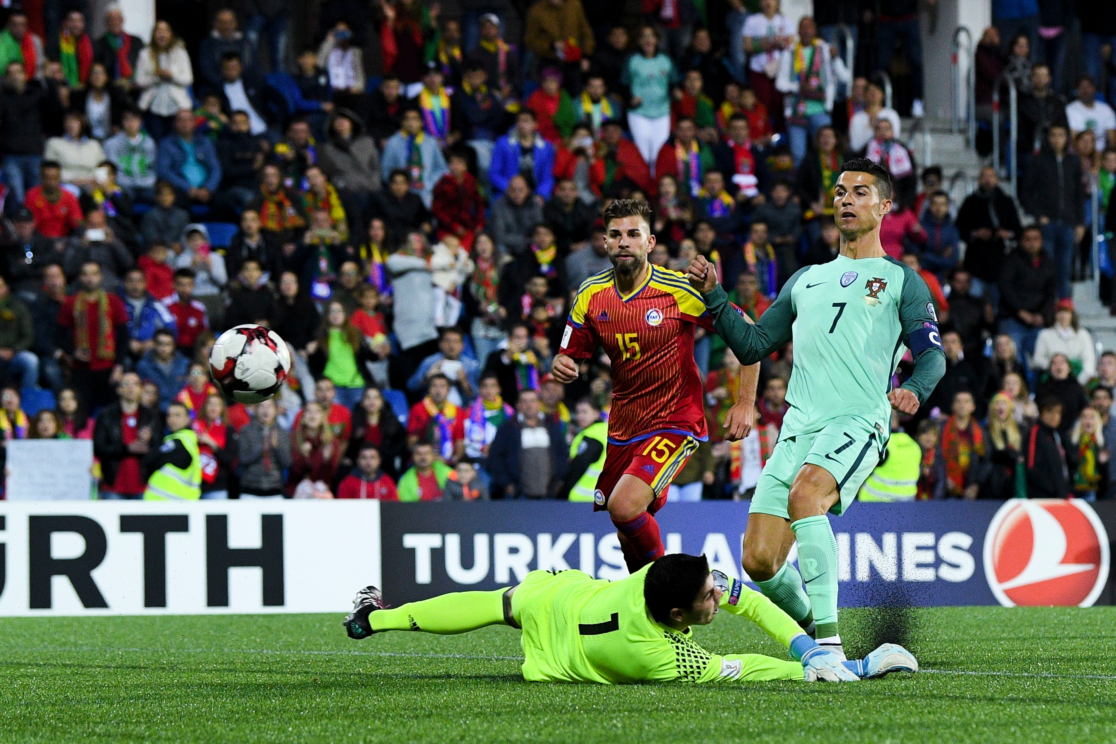 ANDORRA LA VELLA, ANDORRA - OCTOBER 07: Cristiano Ronaldo of Portugal scores the opening goal past the goalkeeper Josep Gomes of Andorraduring the FIFA 2018 World Cup Qualifier between Andorra and Portugal at the Estadi Nacional on October 7, 2017 in And ANDORRA LA VELLA, ANDORRA - OCTOBER 07: Cristiano Ronaldo of Portugal scores the opening goal past the goalkeeper Josep Gomes of Andorraduring the FIFA 2018 World Cup Qualifier between Andorra and Portugal at the Estadi Nacional on October 7, 2017 in And