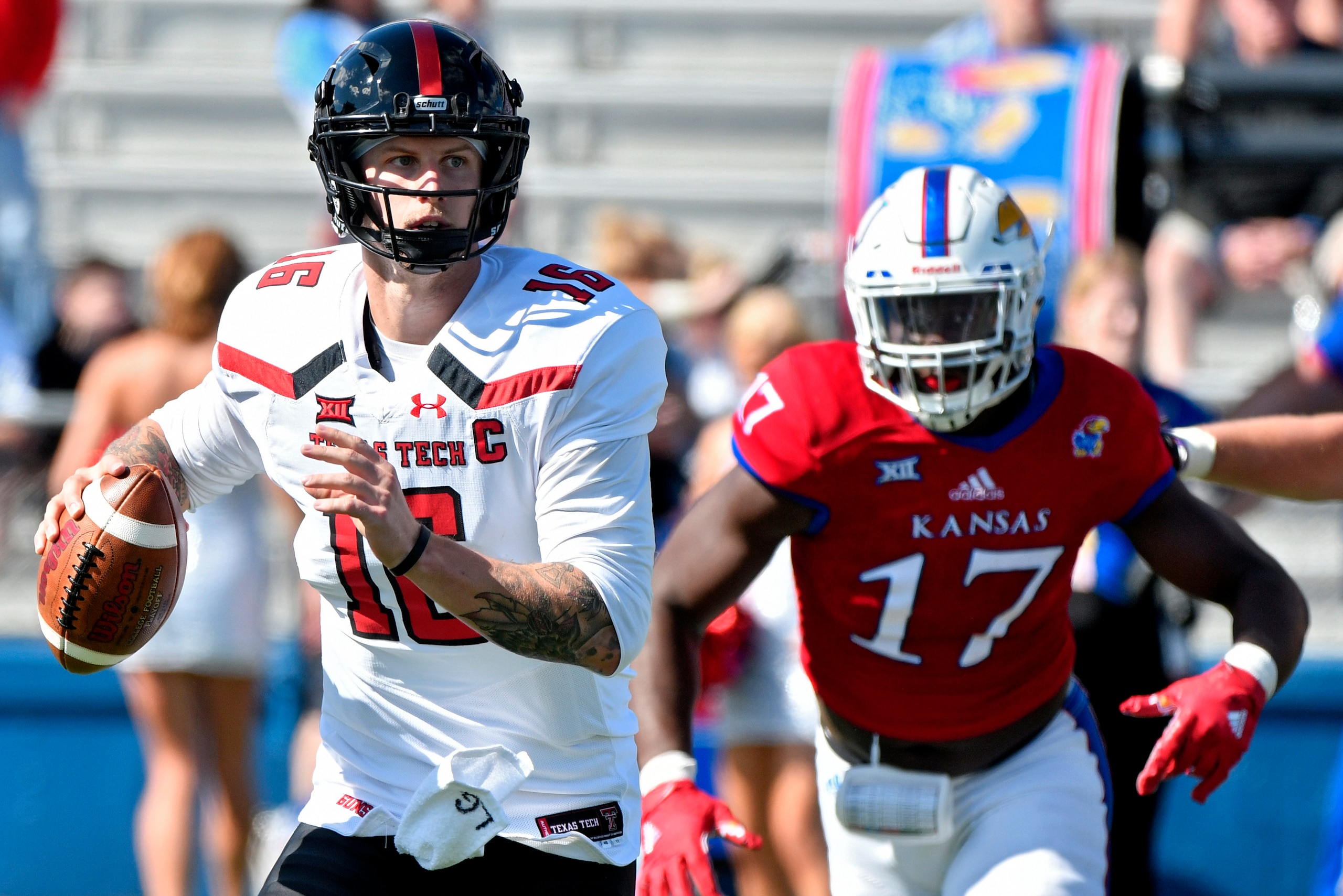 LAWRENCE, KS - OCTOBER 7: Quarterback Nic Shimonek #16 of the Texas Tech Red Raiders looks to pass against defensive end Josh Ehambe #17 of the Kansas Jayhawks in the second quarter at Memorial Stadium on October 7, 2017 in Lawrence, Kansas. (Photo by Ed 