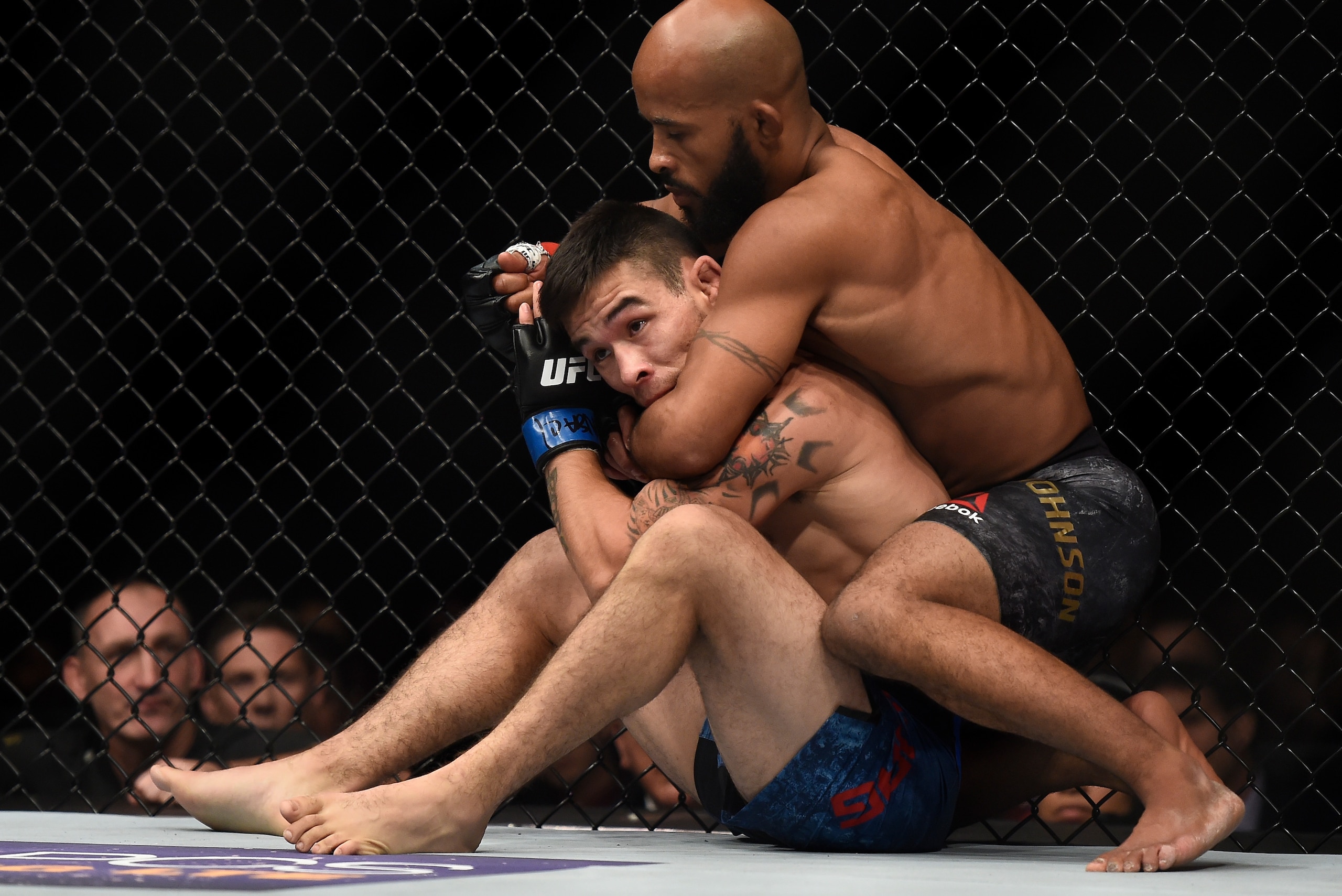 LAS VEGAS, NV - OCTOBER 07:   (R-L) Demetrious Johnson attempts to secure a rear choke against Ray Borg in their UFC flyweight championship bout during the UFC 216 event inside T-Mobile Arena on October 7, 2017 in Las Vegas, Nevada. (Photo by Brandon Magn
