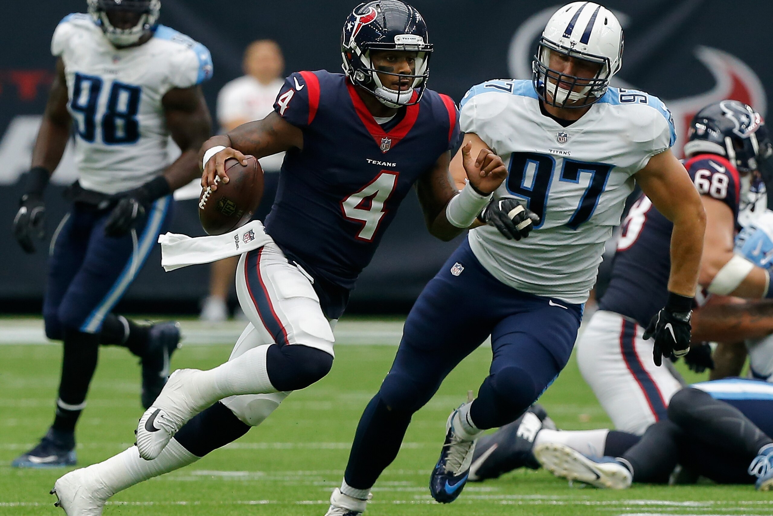 HOUSTON, TX - OCTOBER 01:  Deshaun Watson #4 of the Houston Texans rushes with the ball as Karl Klug #97 of the Tennessee Titans pursues in the second quarter at NRG Stadium on October 1, 2017 in Houston, Texas.  (Photo by Bob Levey/Getty Images)