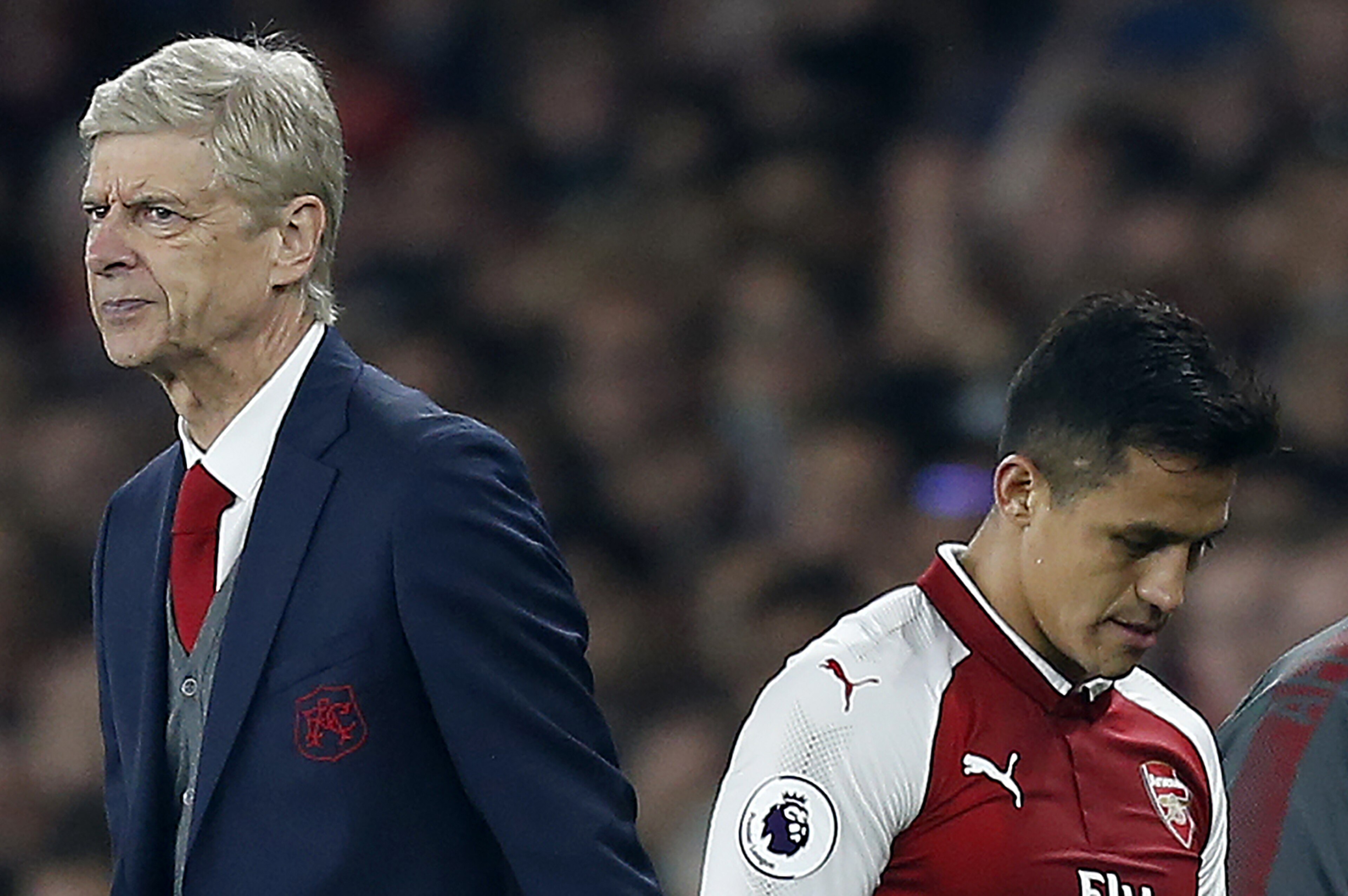 Arsenal's French manager Arsene Wenger (L) reacts as Arsenal's Chilean striker Alexis Sanchez is substituted off of the pitch during the English Premier League football match between Arsenal and West Bromwich Albion at the Emirates Stadium in London on Se