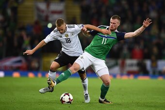BELFAST, NORTHERN IRELAND - OCTOBER 05: Chris Brunt of Northern Ireland is tackled by Joshua Kimmich of Germany during the FIFA 2018 World Cup Qualifier between Northern Ireland and Germany at Windsor Park on October 5, 2017 in Belfast, Northern Ireland. 