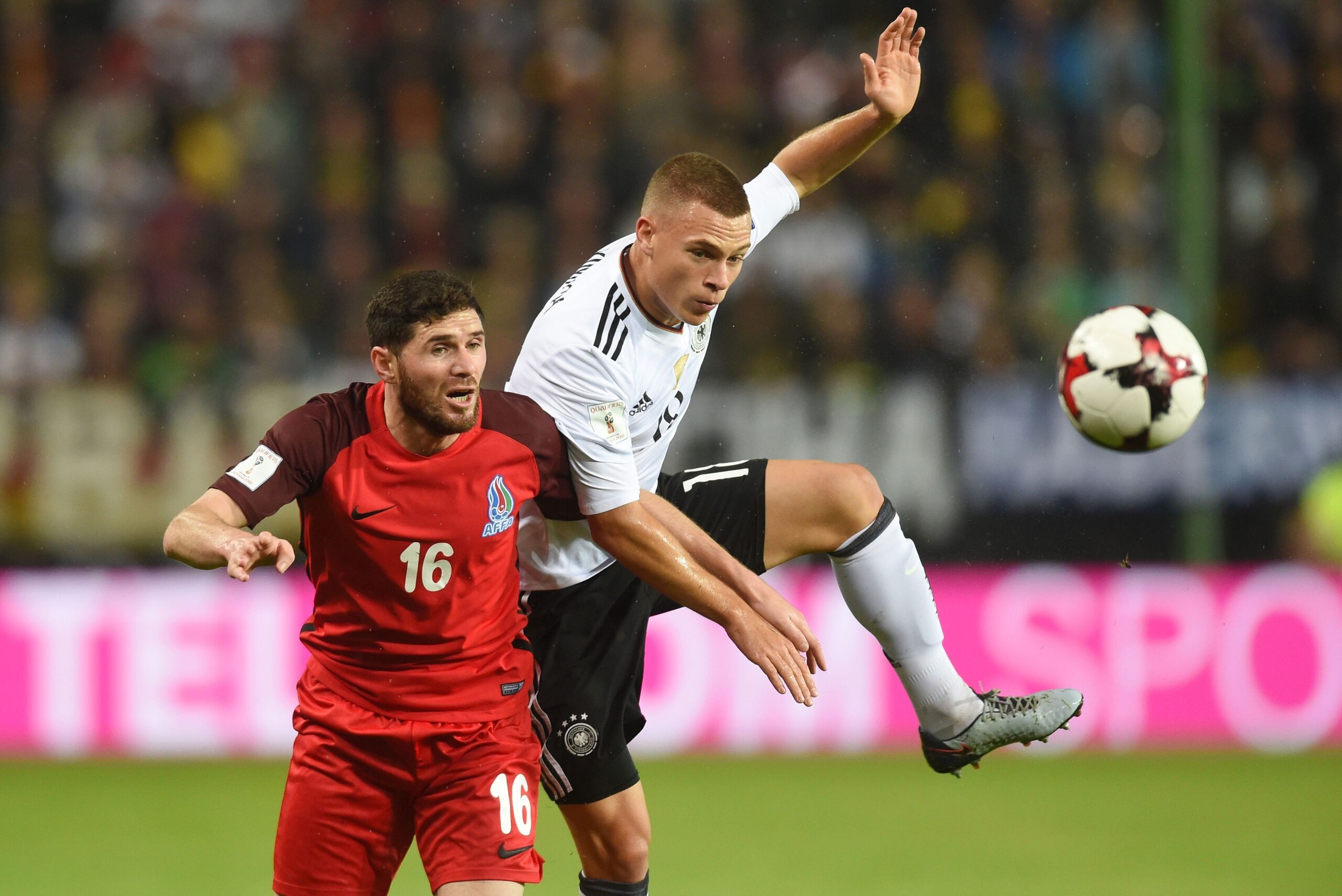 Germany's defender Joshua Kimmich (R) and Azerbaijan's midfielder Javid Hueseynov (L) vie for the ball during the FIFA World Cup 2018 qualification football match between Germany and Azerbaijan in Mainz, western Germany, on October 8, 2017. / AFP PHOTO / 
