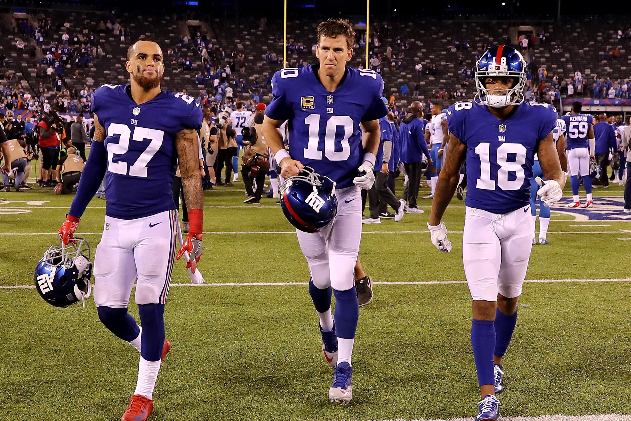 EAST RUTHERFORD, NJ - SEPTEMBER 18:    Darian Thompson#27, Eli Manning #10 and  Roger Lewis #18 of the New York Giants walk off the field after the game against the Detroit Lions on September 18, 2017 at MetLife Stadium in East Rutherford, New Jersey.  (P