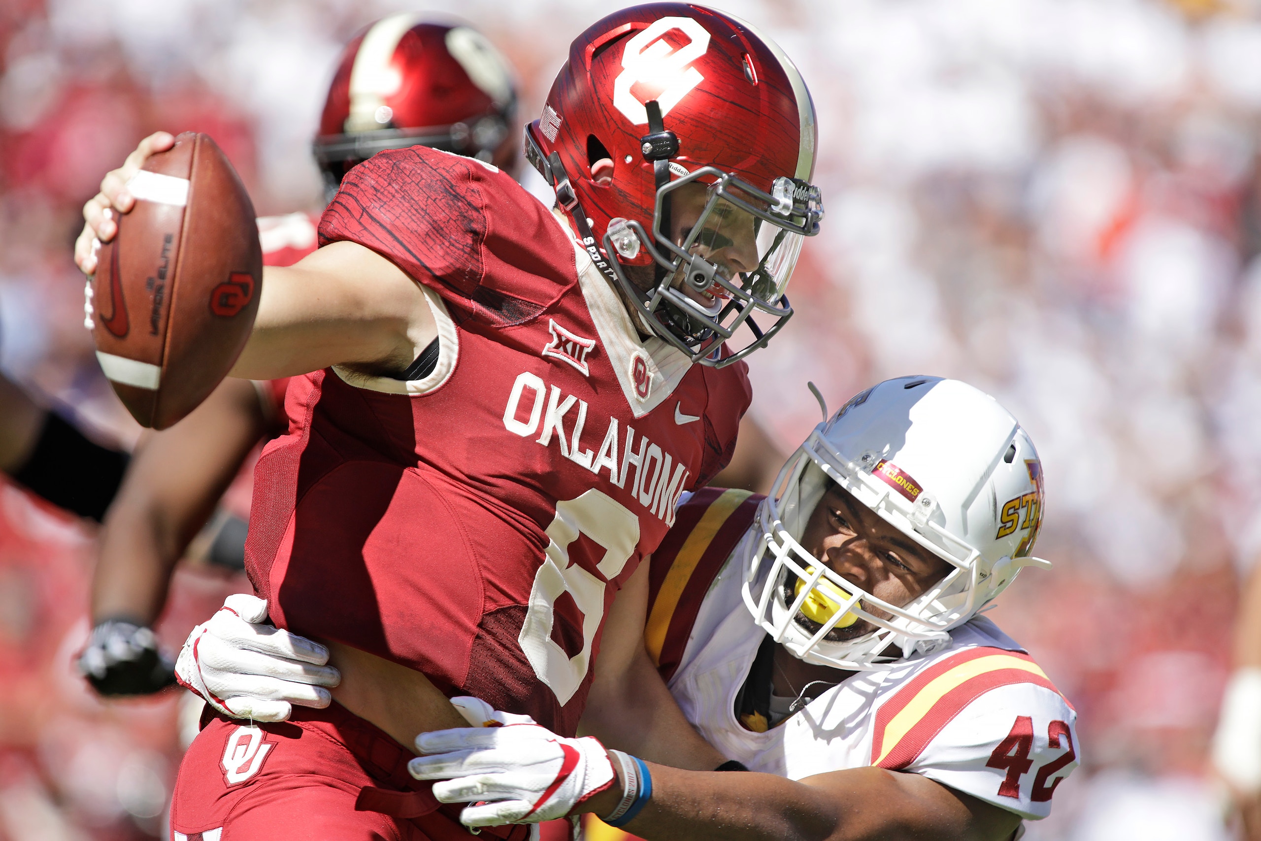 NORMAN, OK - OCTOBER 07: Quarterback Baker Mayfield #6 of the Oklahoma Sooners is hit by linebacker Marcel Spears Jr. #42 of the Iowa State Cyclones at Gaylord Family Oklahoma Memorial Stadium on October 7, 2017 in Norman, Oklahoma. (Photo by Brett Deerin