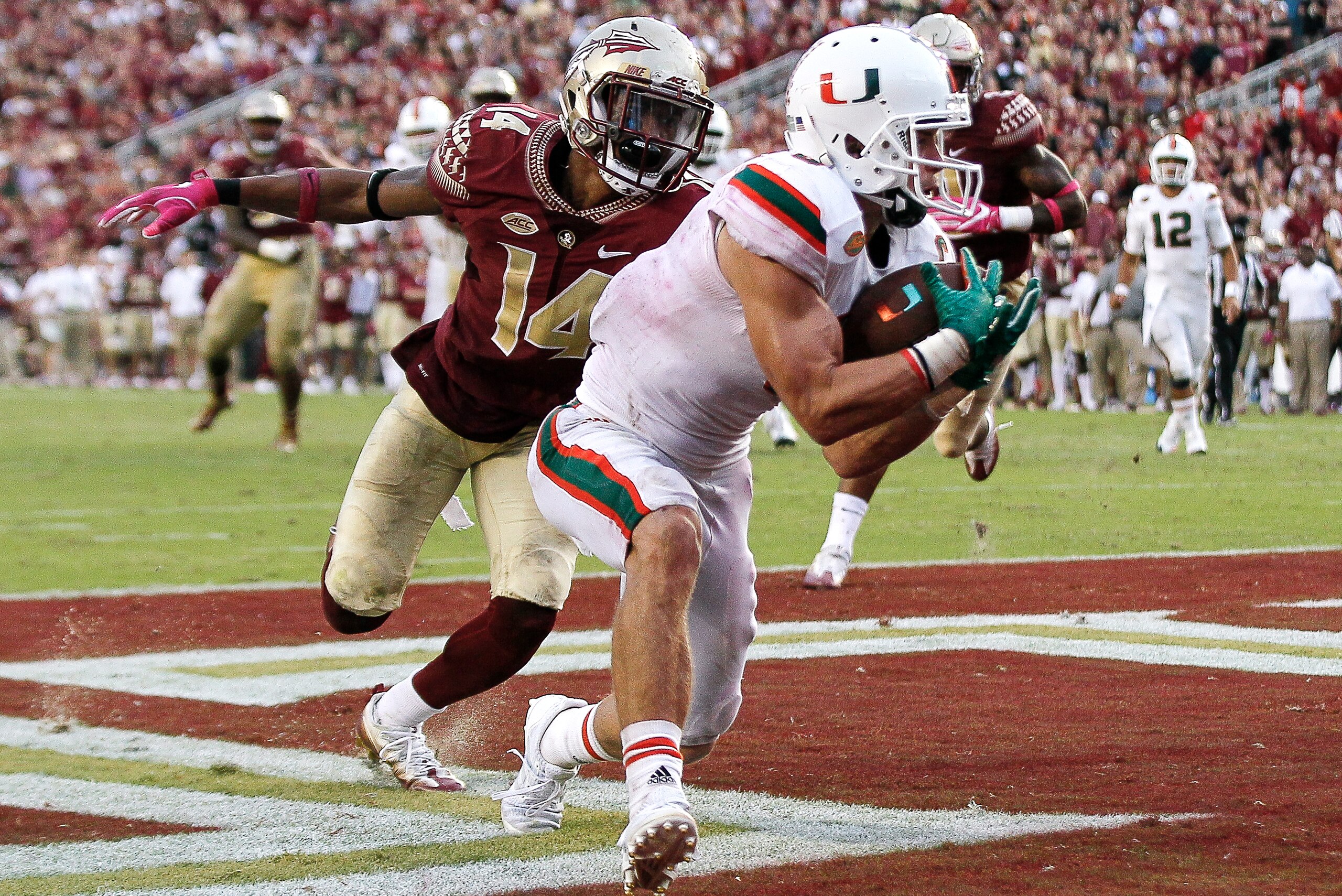 TALLAHASSEE, FL - OCTOBER 7: Wide Receiver Braxton Berrios #8 of the Miami Hurricanes makes a touchdown catch over Defensive Back Kyle Meyers #14 of the Florida State Seminoles at Doak Campbell Stadium on Bobby Bowden Field on October 7, 2017 in Tallahass