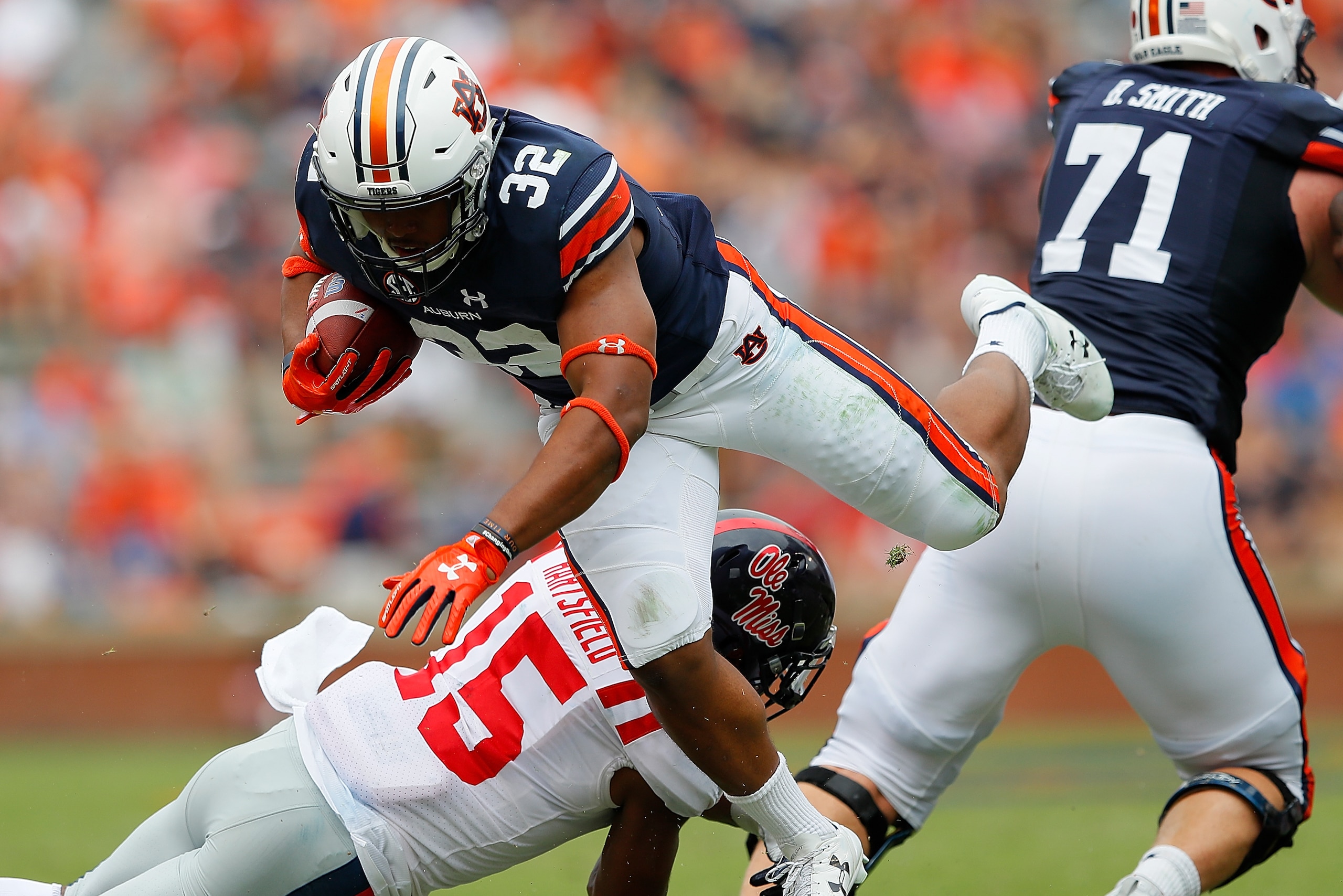 AUBURN, AL - OCTOBER 07:  Myles Hartsfield #15 of the Mississippi Rebels tackles Malik Miller #32 of the Auburn Tigers at Jordan Hare Stadium on October 7, 2017 in Auburn, Alabama.  (Photo by Kevin C. Cox/Getty Images)