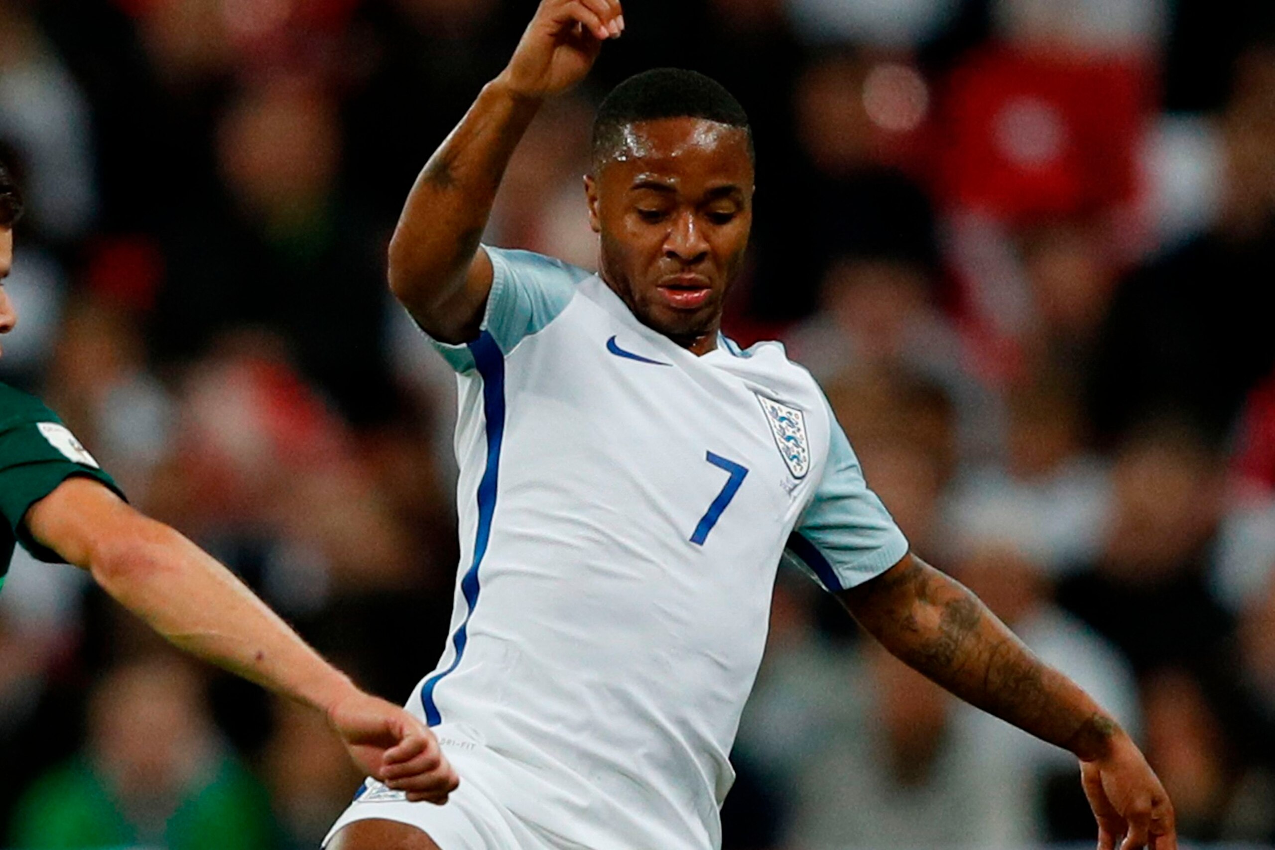 Slovenia's forward Roman Bezjak (L) challenges England's midfielder Raheem Sterling (R) during the FIFA World Cup 2018 qualification football match between England and Slovenia at Wembley Stadium in London on October 5, 2017.  / AFP PHOTO / Adrian DENNIS 