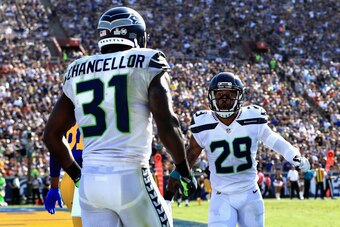 LOS ANGELES, CA - OCTOBER 08:   Kam Chancellor #31 celebrates a broken pass play with  Earl Thomas #29 of the Seattle Seahawks during the second half of a game against the Los Angeles Rams   at Los Angeles Memorial Coliseum on October 8, 2017 in Los Angel