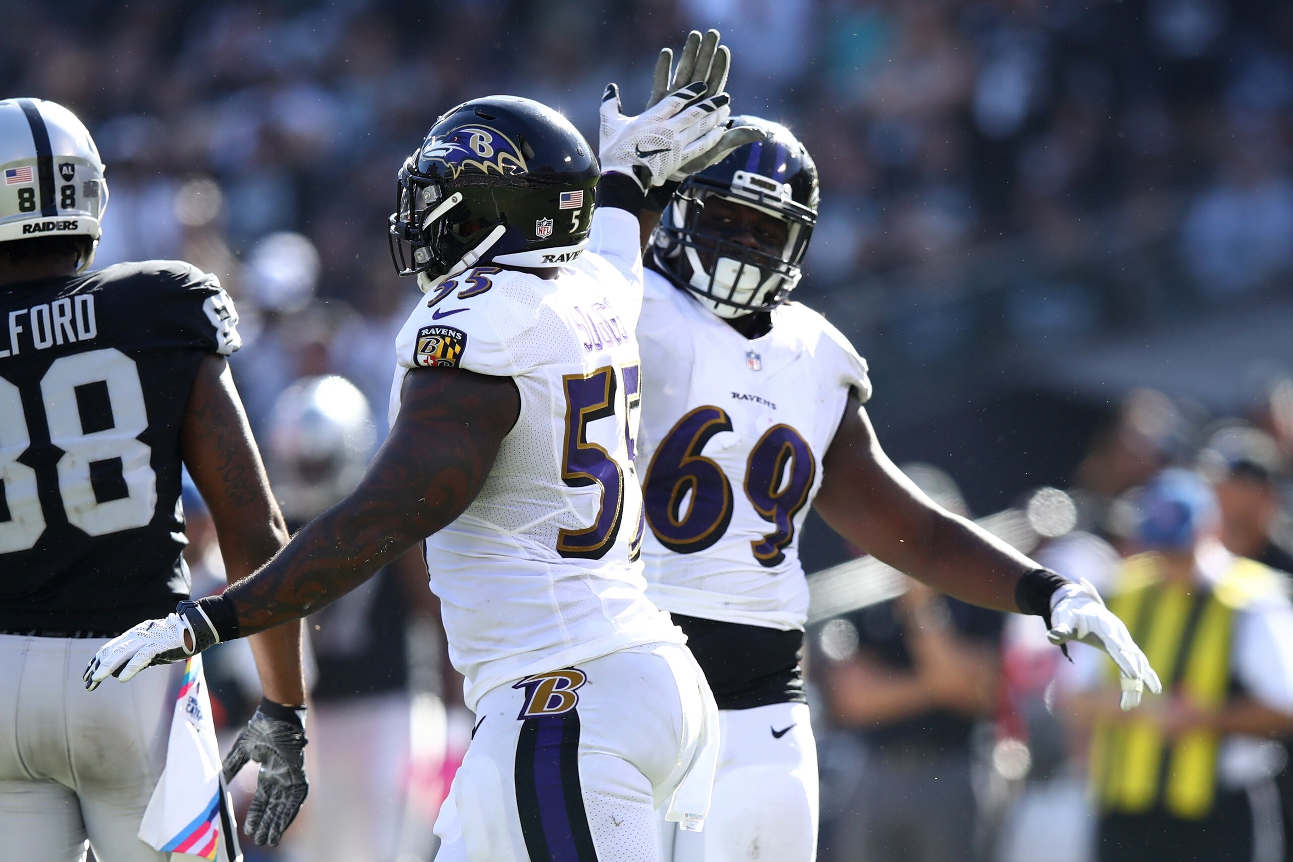 OAKLAND, CA - OCTOBER 08:  Terrell Suggs #55 of the Baltimore Ravens celebrates after a sack with Willie Henry #69 during their NFL game against the Oakland Raiders at Oakland-Alameda County Coliseum on October 8, 2017 in Oakland, California.  (Photo by E