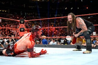 Bray Wyatt pours a mystery red substance onto Finn Balor.
