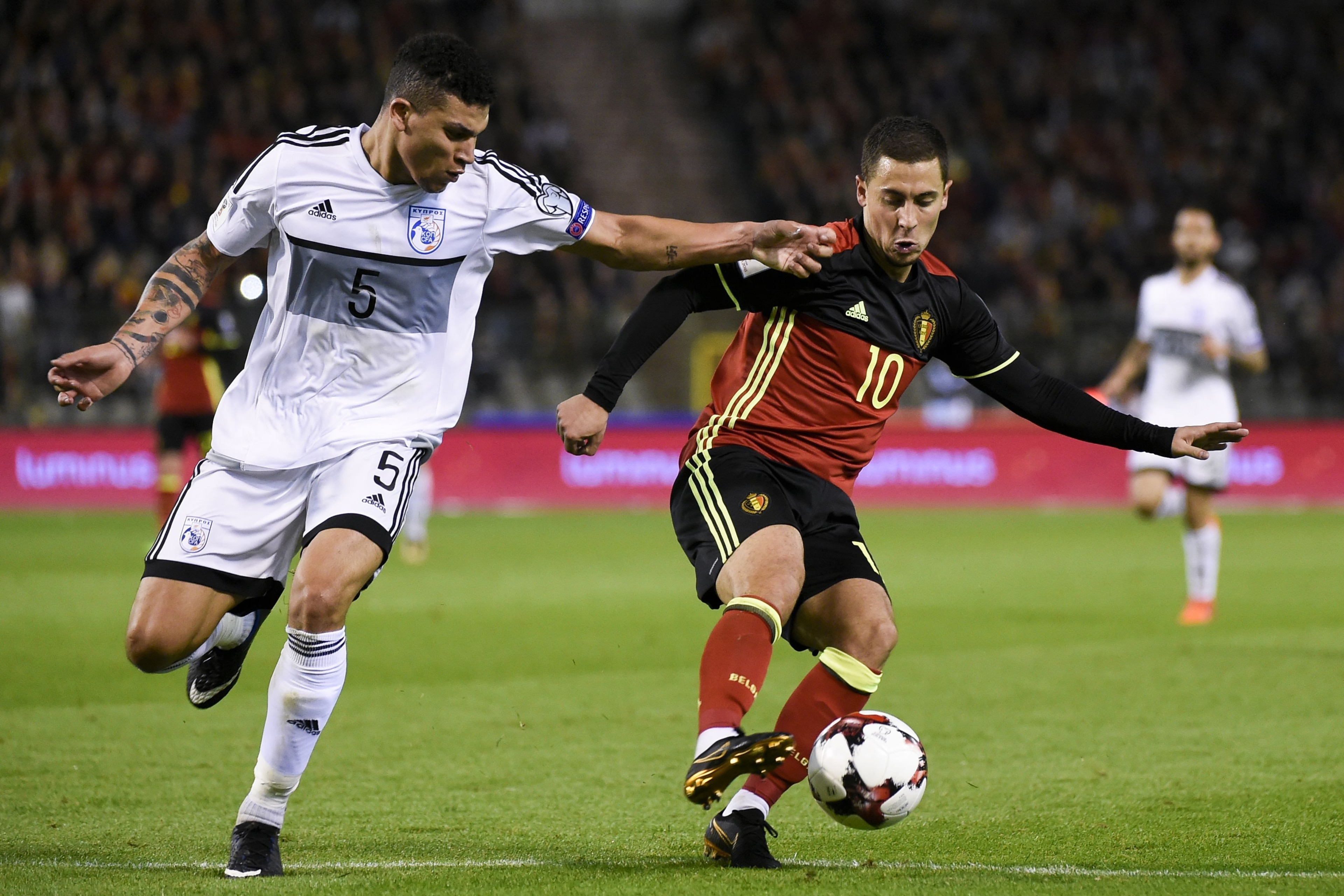 Cyprus' defender Fanos Katelaris (L) vies with Belgium's midfielder Eden Hazard during the FIFA World Cup 2018 qualification football match between Belgium and Cyprus, at the King Baudouin Stadium, on October 10, 2017 in Brussels. / AFP PHOTO / JOHN THYS 