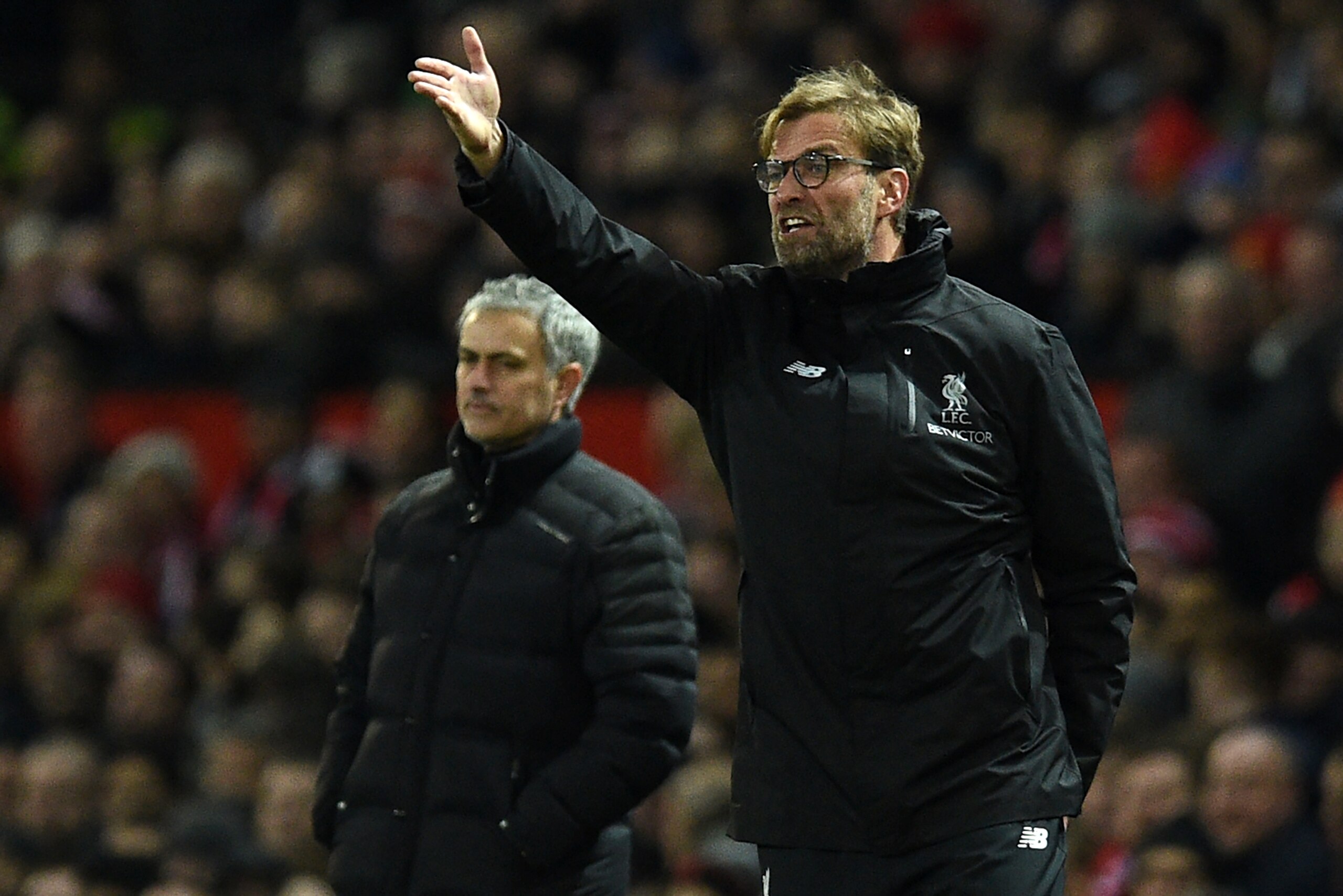 Manchester United's Portuguese manager Jose Mourinho (L) looks on as Liverpool's German manager Jurgen Klopp shouts instructions to his players from the touchline during the English Premier League football match between Manchester United and Liverpool at 