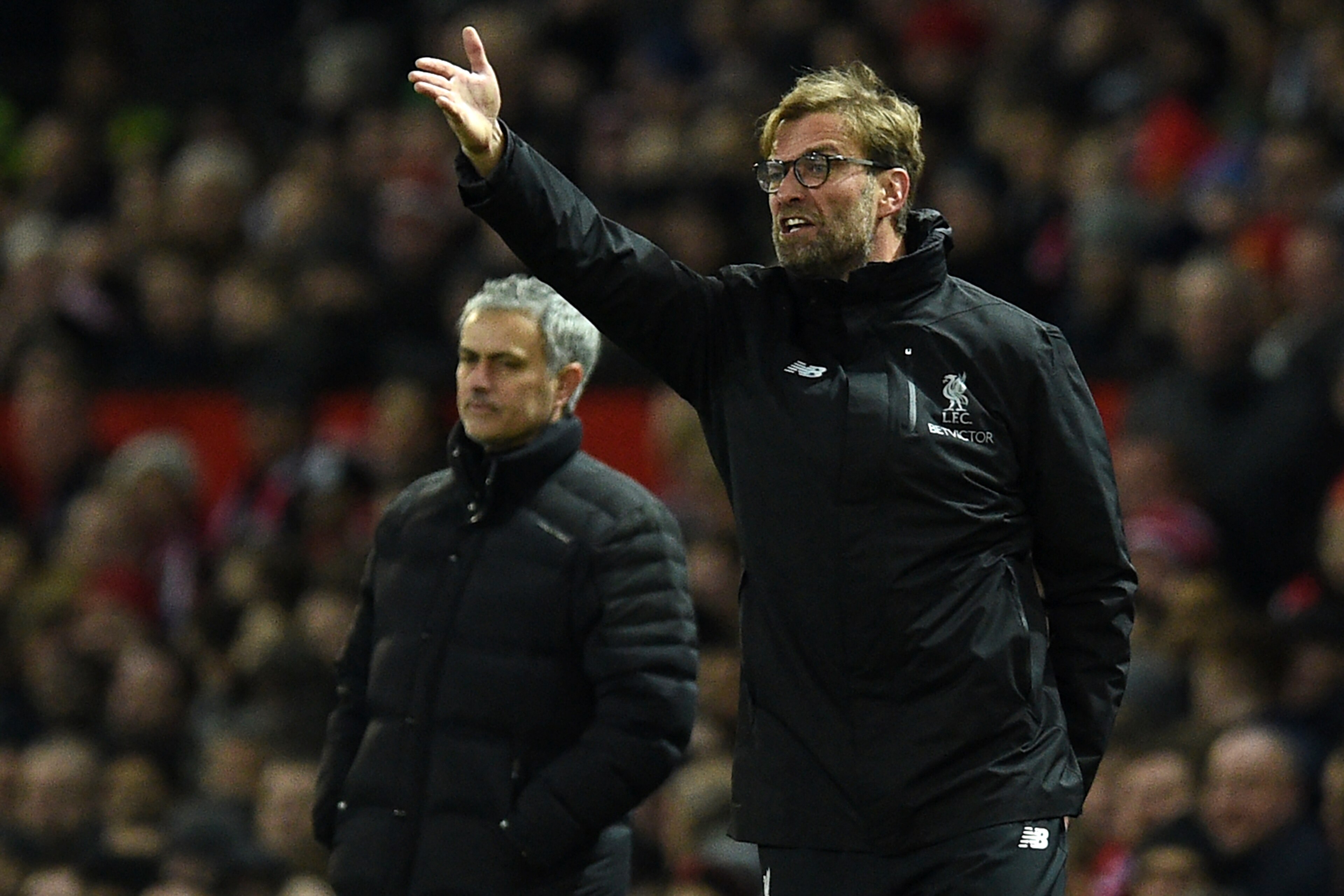 Manchester United's Portuguese manager Jose Mourinho (L) looks on as Liverpool's German manager Jurgen Klopp shouts instructions to his players from the touchline during the English Premier League football match between Manchester United and Liverpool at 