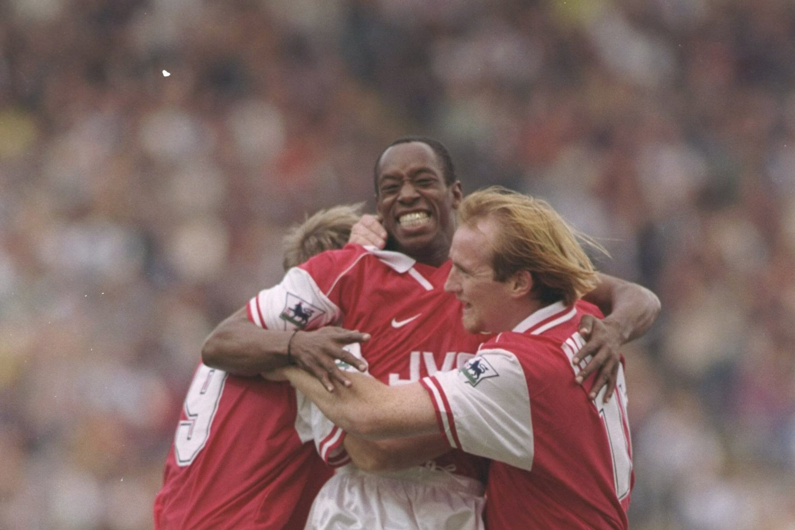 12 Oct 1996:  Ian Wright of Arsenal (centre) celebrates with teammates John Hartson (right) and Paul Merson (left) after scoring the first of his two goals during the FA Carling Premier league match between Blackburn Rovers and Arsenal at Ewood Park in Bl