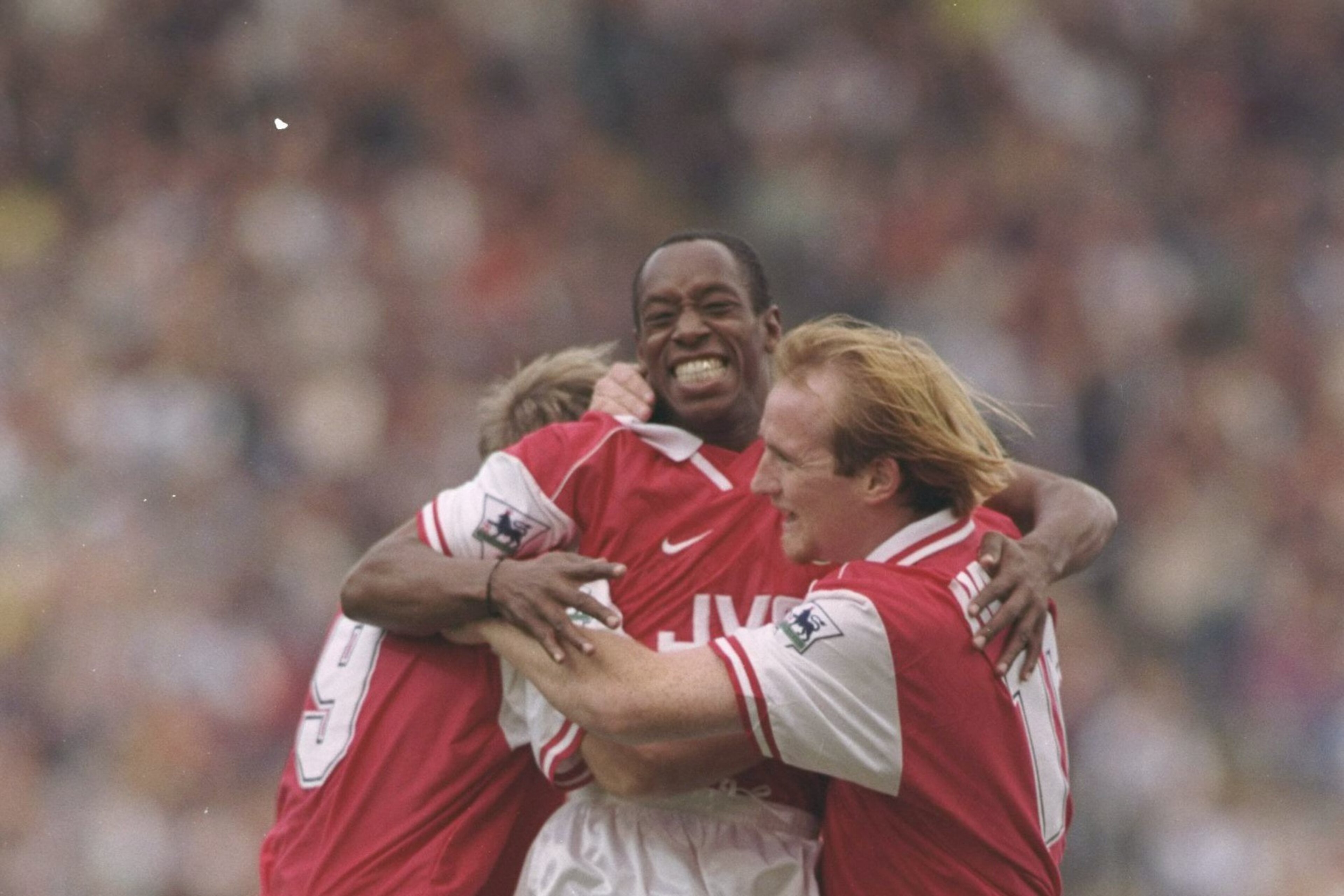 12 Oct 1996:  Ian Wright of Arsenal (centre) celebrates with teammates John Hartson (right) and Paul Merson (left) after scoring the first of his two goals during the FA Carling Premier league match between Blackburn Rovers and Arsenal at Ewood Park in Bl