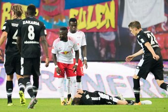 Moenchengladbach´s German midfielder Christoph Kramer lays on the pitch after a heavy foul by Leipzig´s Guinean midfielder Naby Deco Keita (3rd from L) during the German first division Bundesliga football match between RB Leipzig and Borussia Moenchenglad