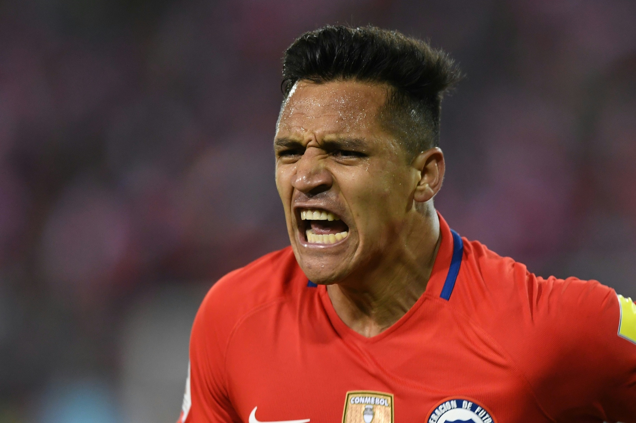 Chile's Alexis Sanchez celebrates after scoring against Ecuador during their 2018 World Cup qualifier football match in Santiago on October 5, 2017. / AFP PHOTO / Martin BERNETTI        (Photo credit should read MARTIN BERNETTI/AFP/Getty Images)