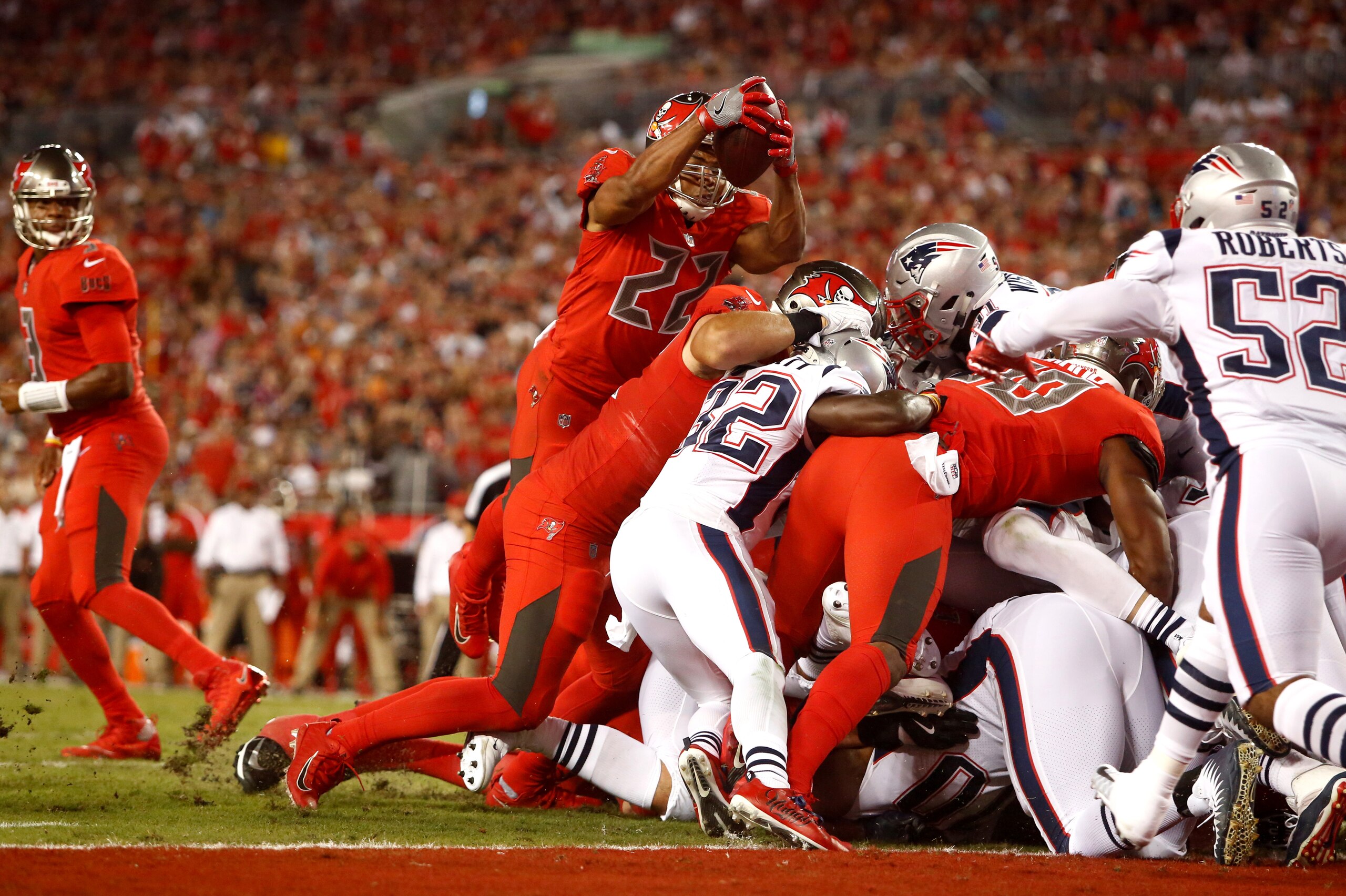 TAMPA, FL - OCTOBER 5:  Running back Doug Martin #22 of the Tampa Bay Buccaneers goes over the top on a one-yard rush for a touchdown during the second quarter of an NFL football game against the New England Patriots on October 5, 2017 at Raymond James St