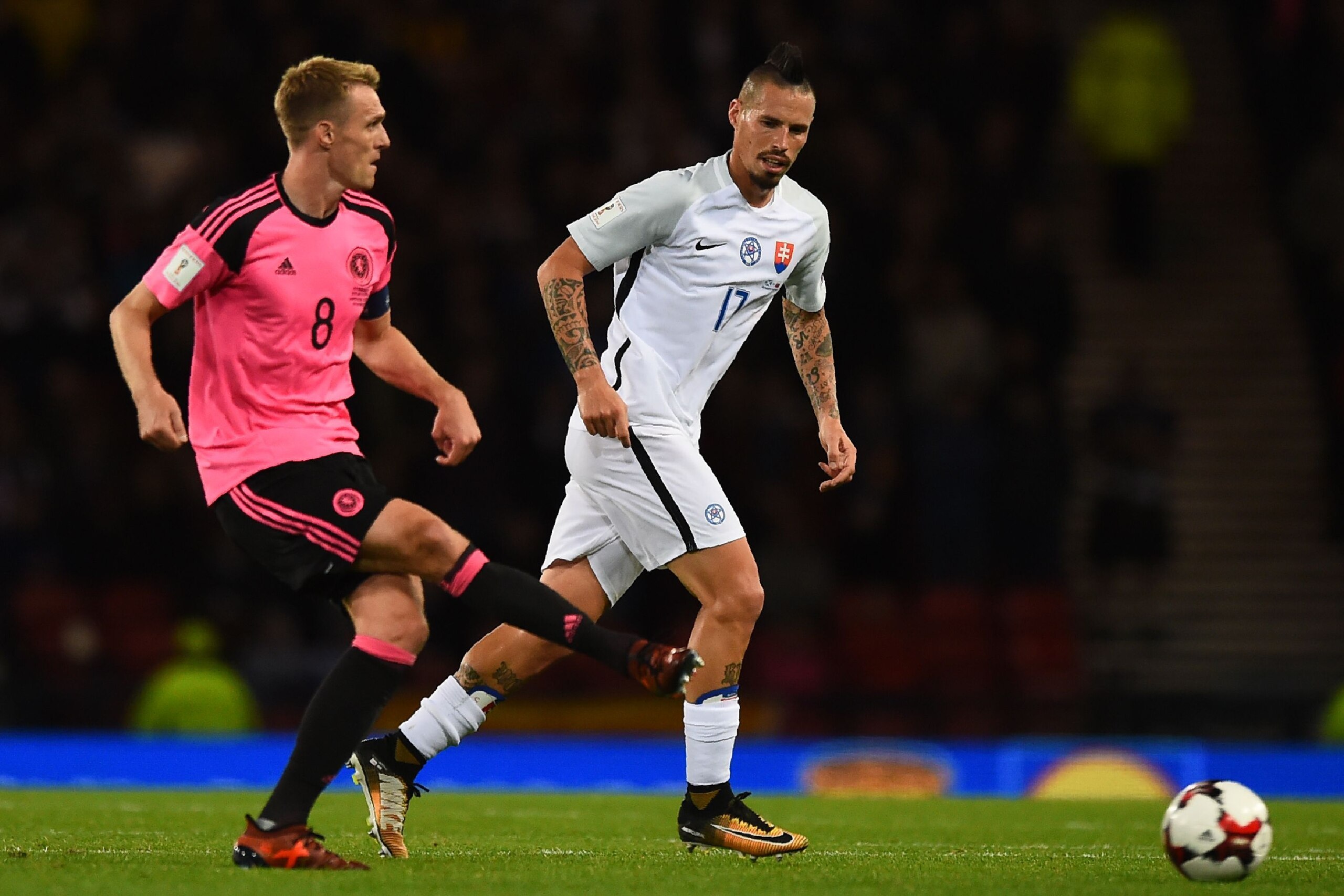 Scotland's midfielder Darren Fletcher (L) passes the ball in front of Slovakia's midfielder Marek Hamsik during the FIFA World Cup 2018 qualifying football match between Scotland and Slovakia at Hampden Park in Glasgow on October 5, 2017. / AFP PHOTO / An