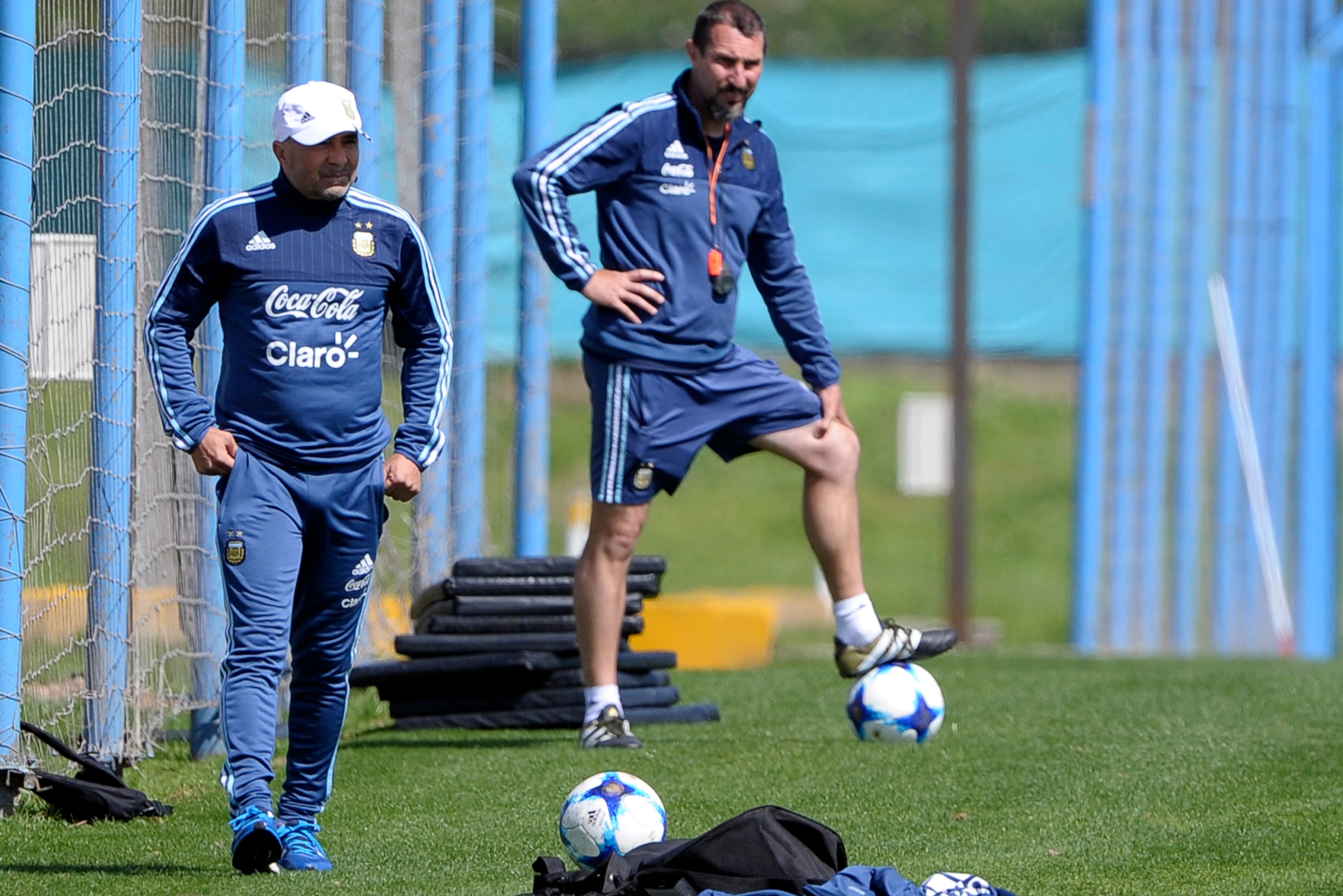 Argentina's team coach Jorge Sampaoli (L) watches his players during a training session in Ezeiza, Buenos Aires on October 7, 2017 ahead of a 2018 FIFA World Cup South American qualifier football match against Ecuador to be held in Quito on October 10.  /