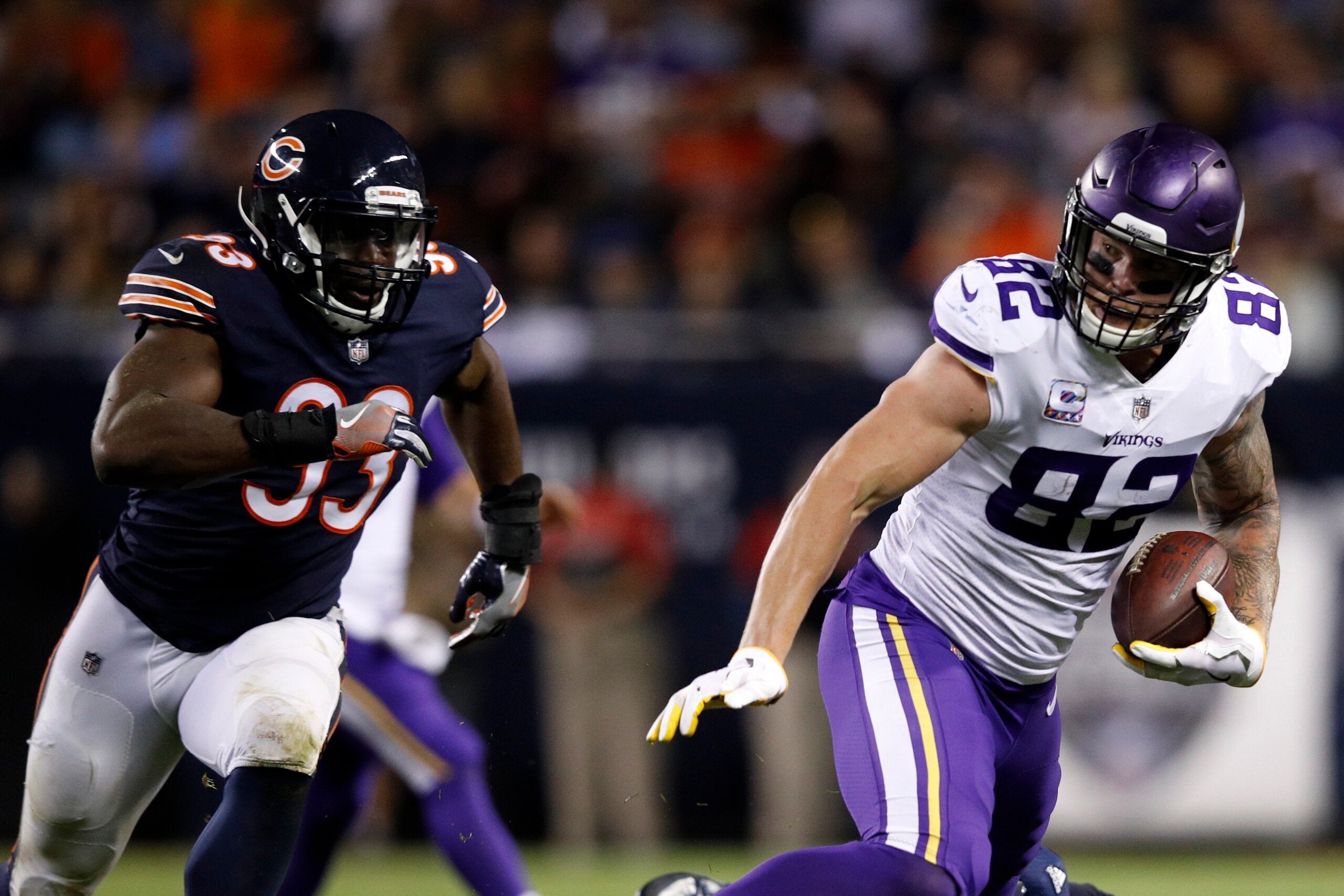 CHICAGO, IL - OCTOBER 09:  Kyle Rudolph #82 of the Minnesota Vikings carries the football ahead of Sam Acho #93 of the Chicago Bears in the third quarter at Soldier Field on October 9, 2017 in Chicago, Illinois. The Minnesota Vikings defeated the Chicago 