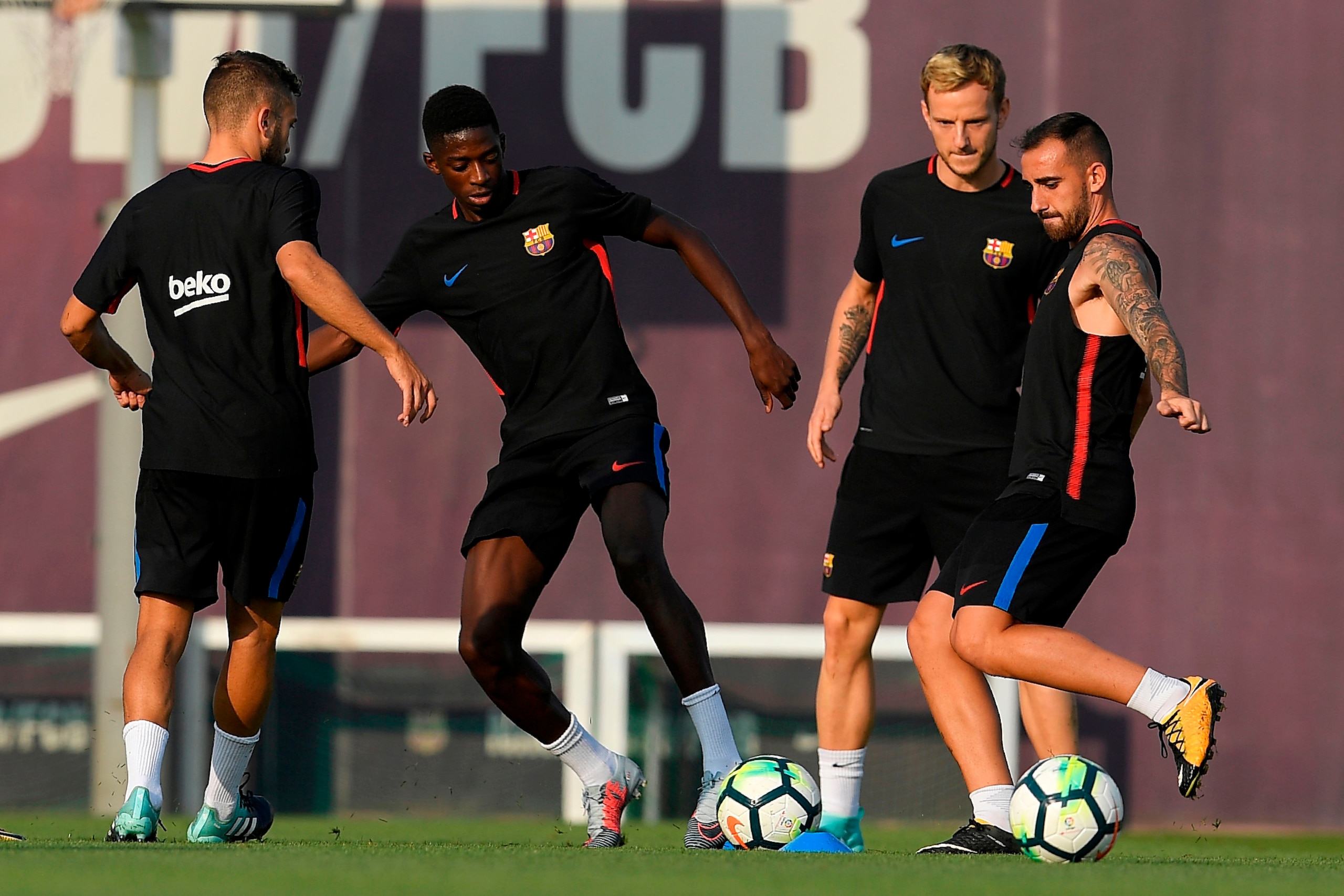 (FromL) Barcelona's defender Jordi Alba, Barcelona's French forward Ousmane Dembele, Barcelona's Croatian midfielder Ivan Rakitic and Barcelona's forward Paco Alcacer play with a ball during a training session at the Sports Center FC Barcelona Joan Gamper (FromL) Barcelona's defender Jordi Alba, Barcelona's French forward Ousmane Dembele, Barcelona's Croatian midfielder Ivan Rakitic and Barcelona's forward Paco Alcacer play with a ball during a training session at the Sports Center FC Barcelona Joan Gamper