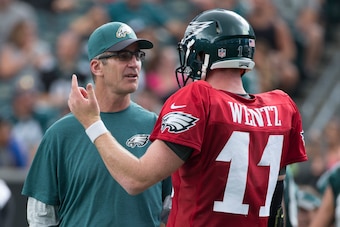 Philadelphia Eagles offensive coordinator Frank Reich talking with quarterback Carson Wentz.
