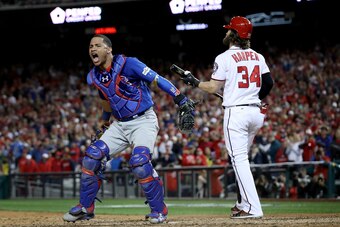 WASHINGTON, DC - OCTOBER 13:  Willson Contreras #40 of the Chicago Cubs celebrates next to Bryce Harper #34 of the Washington Nationals after Harper struck out to end Game 5 of the National League Divisional Series at Nationals Park on October 13, 2017 in