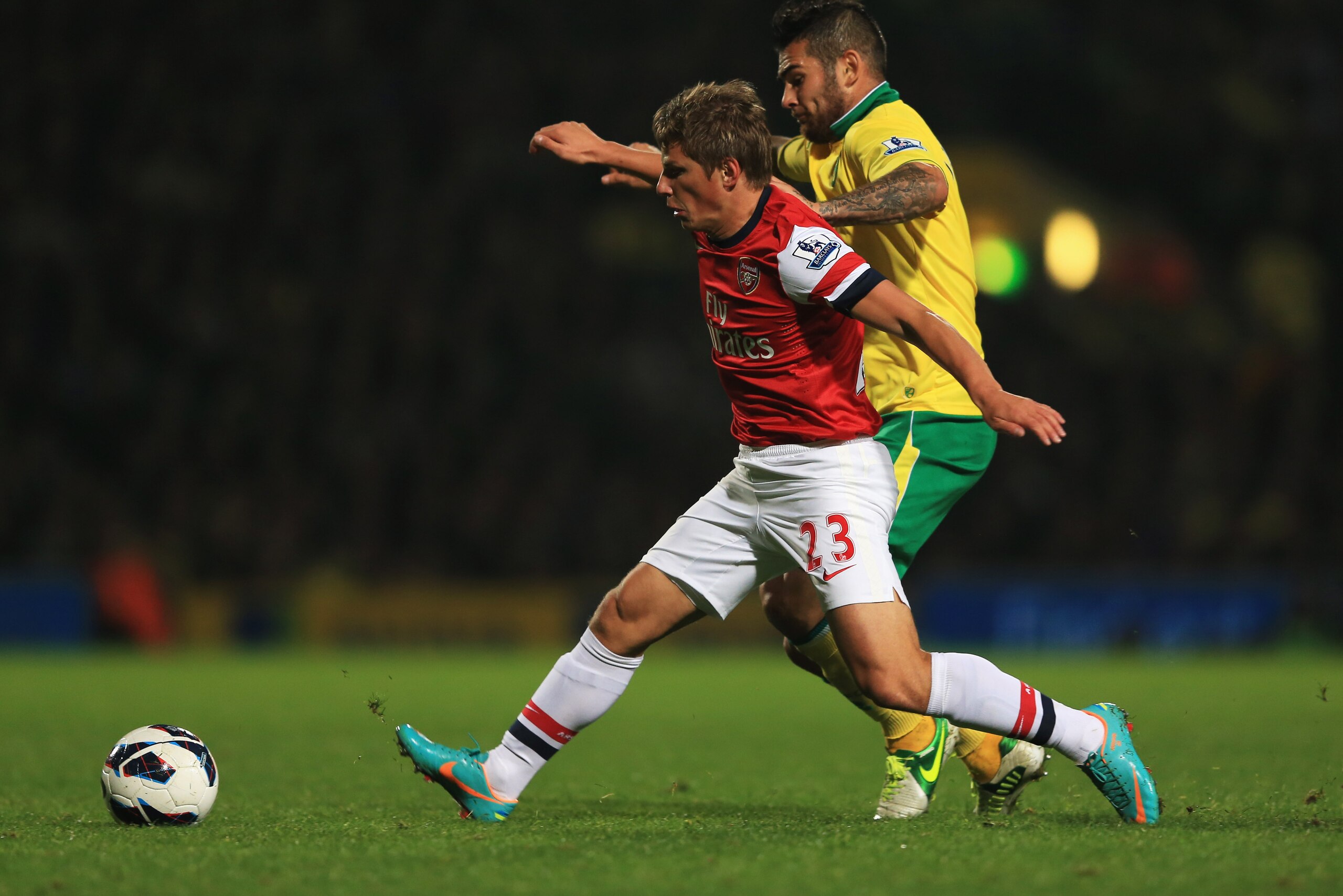 NORWICH, ENGLAND - OCTOBER 20:  Andrey Arshavin of Arsenal holds off Bradley Johnson of Norwich City during the Barclays Premier League match between  Norwich City and Arsenal at Carrow Road on October 20, 2012 in Norwich, England.  (Photo by Richard Heat