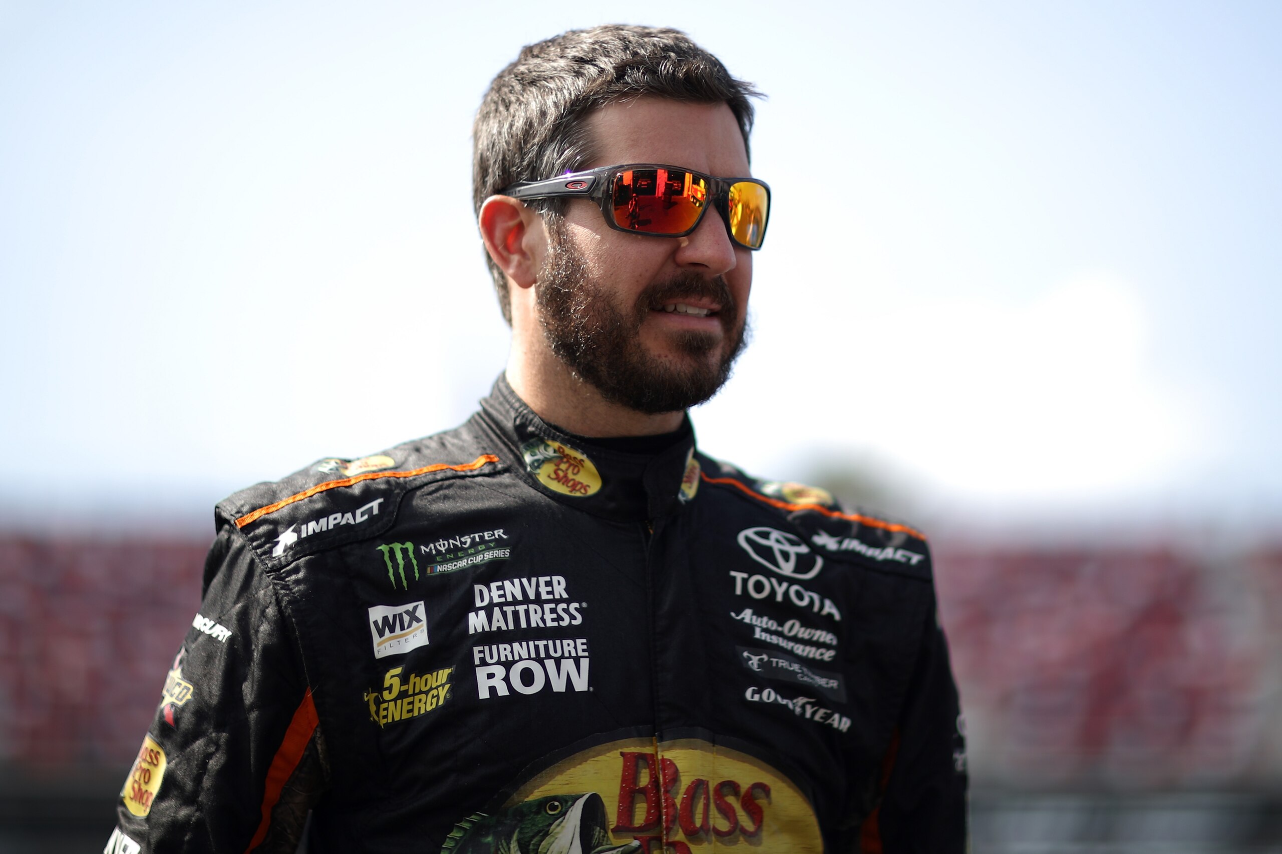 TALLADEGA, AL - OCTOBER 13:  Martin Truex Jr., driver of the #78 Bass Pro Shops/Tracker Boats Toyota, stands in the garage area during practice for the Monster Energy NASCAR Cup Series Alabama 500 at Talladega Superspeedway on October 13, 2017 in Talladeg