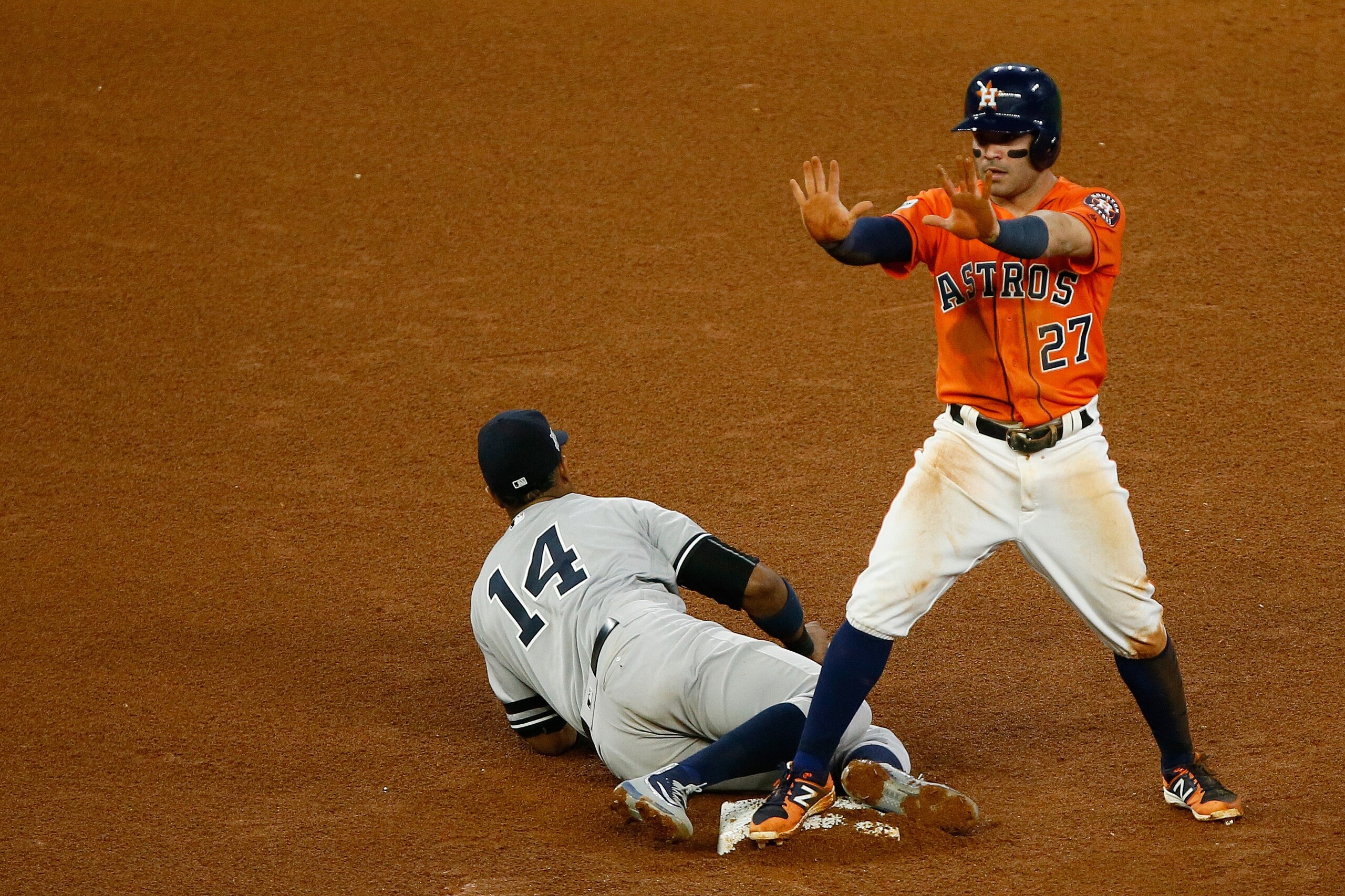 HOUSTON, TX - OCTOBER 13: Jose Altuve #27 of the Houston Astros steals second against Starlin Castro #14 of the New York Yankees in the fourth inning during game one of the American League Championship Series at Minute Maid Park on October 13, 2017 in Ho HOUSTON, TX - OCTOBER 13: Jose Altuve #27 of the Houston Astros steals second against Starlin Castro #14 of the New York Yankees in the fourth inning during game one of the American League Championship Series at Minute Maid Park on October 13, 2017 in Ho