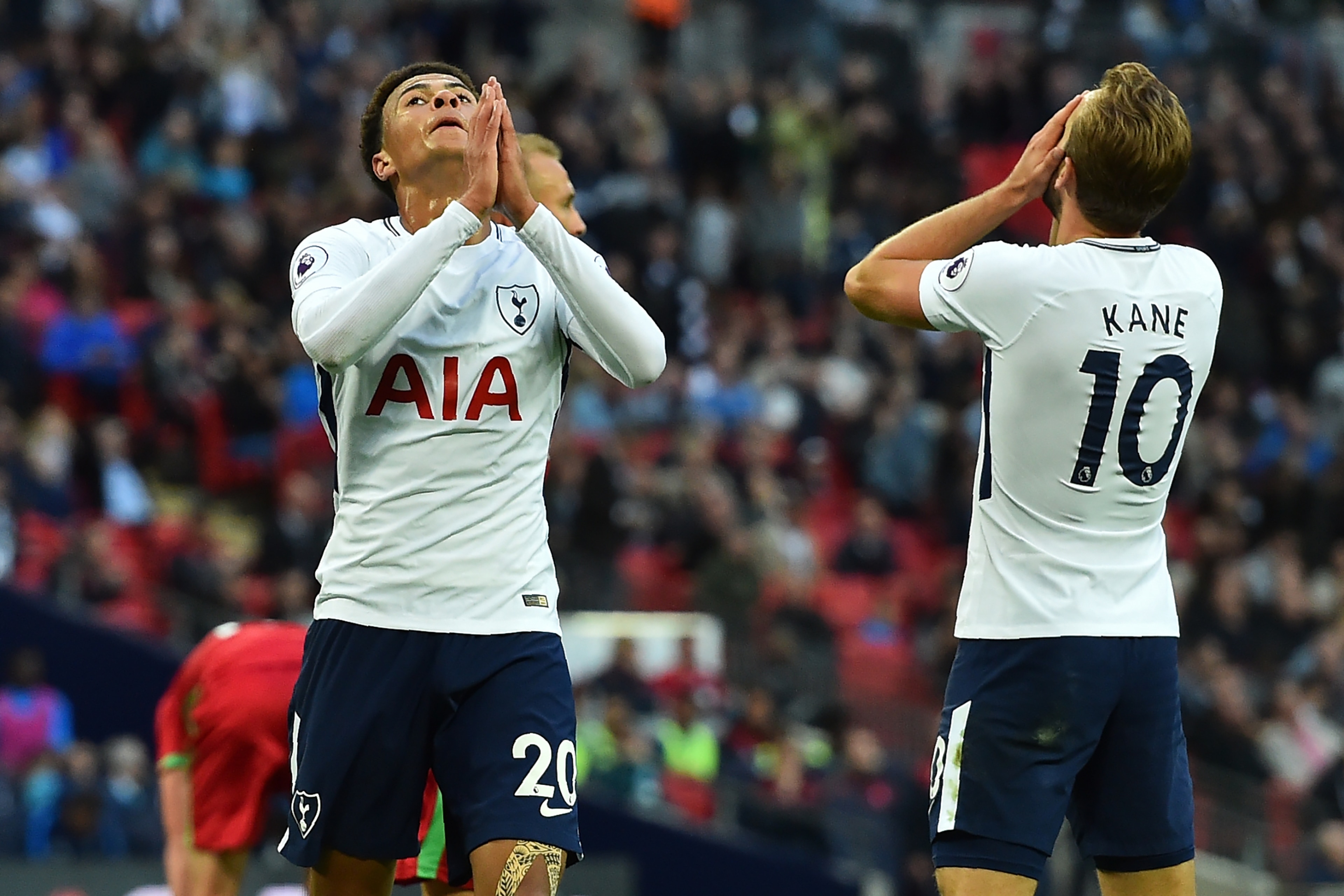 Tottenham Hotspur's English midfielder Dele Alli (L) and Tottenham Hotspur's English striker Harry Kane react to  missing a chance during the English Premier League football match between Tottenham Hotspur and Swansea City at Wembley Stadium in London, on