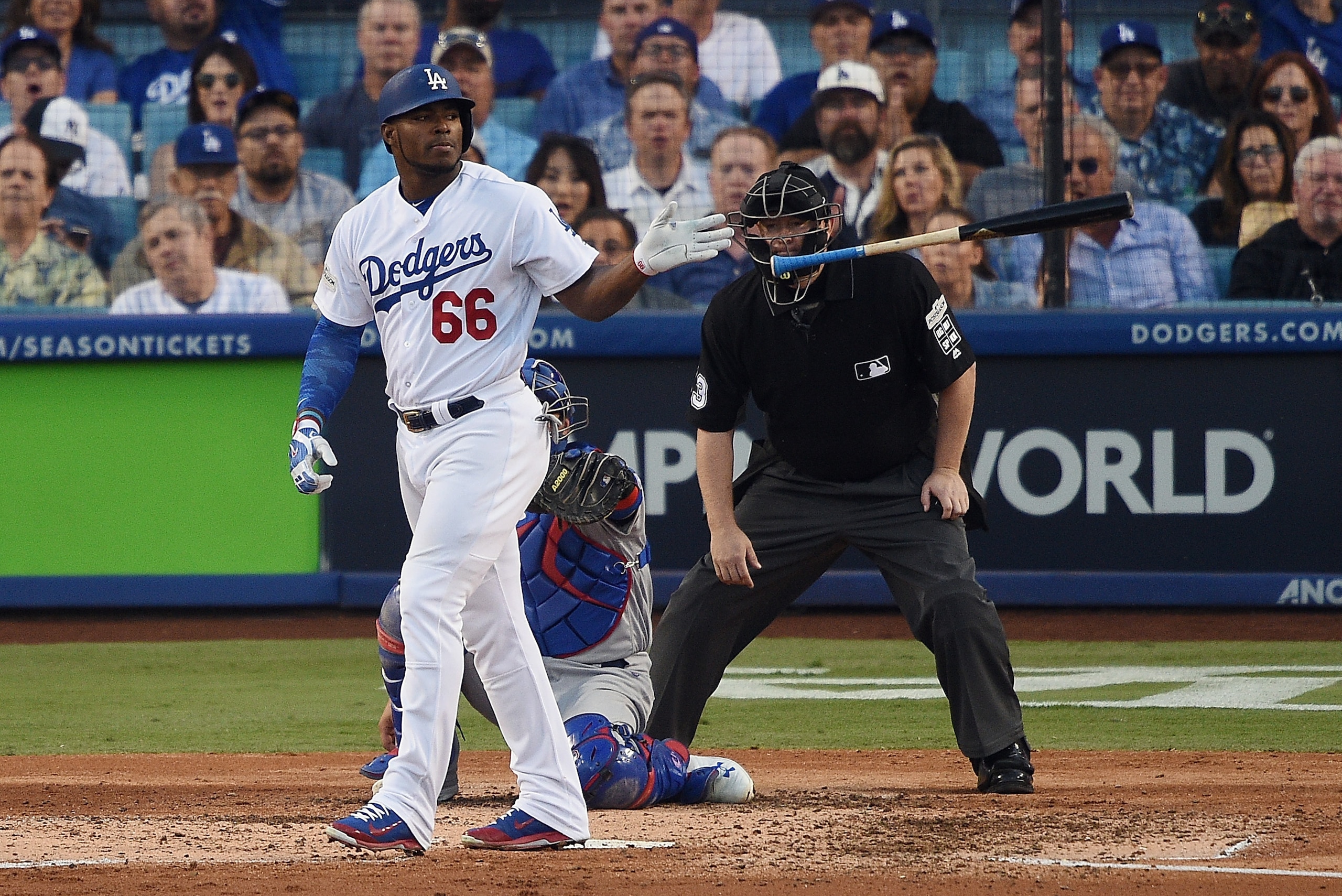 LOS ANGELES, CA - OCTOBER 15:  Yasiel Puig #66 of the Los Angeles Dodgers tosses his bat after being walked in the fourth inning against the Chicago Cubs during game two of the National League Championship Series at Dodger Stadium on October 15, 2017 in L