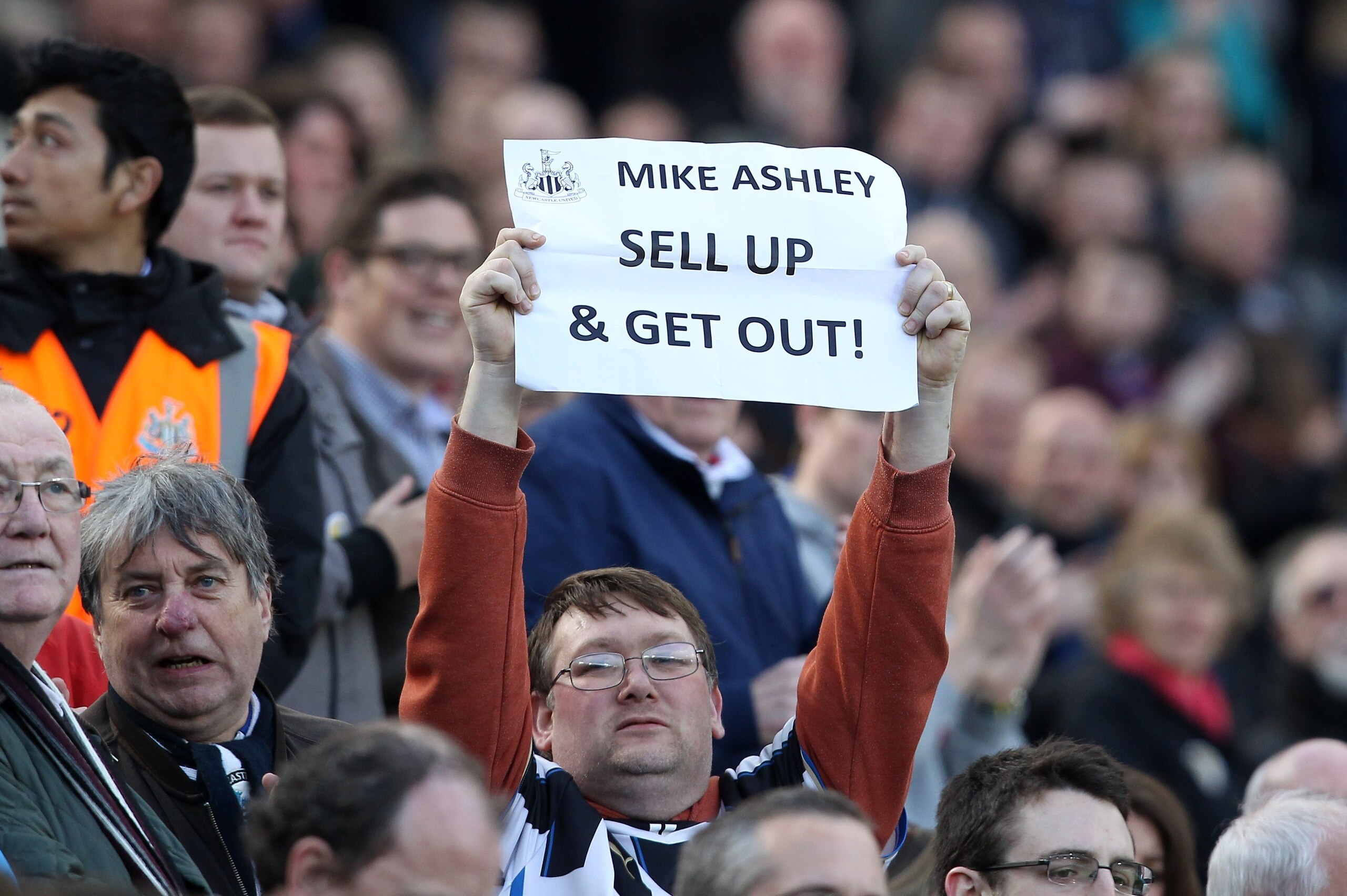 A Newcastle fan protests over owner Mike Ashley, urging him to resign as club director before the English Premier League football match between Newcastle United and Tottenham Hotspur at the St. James' Park stadium in Newcastle, north east England on April