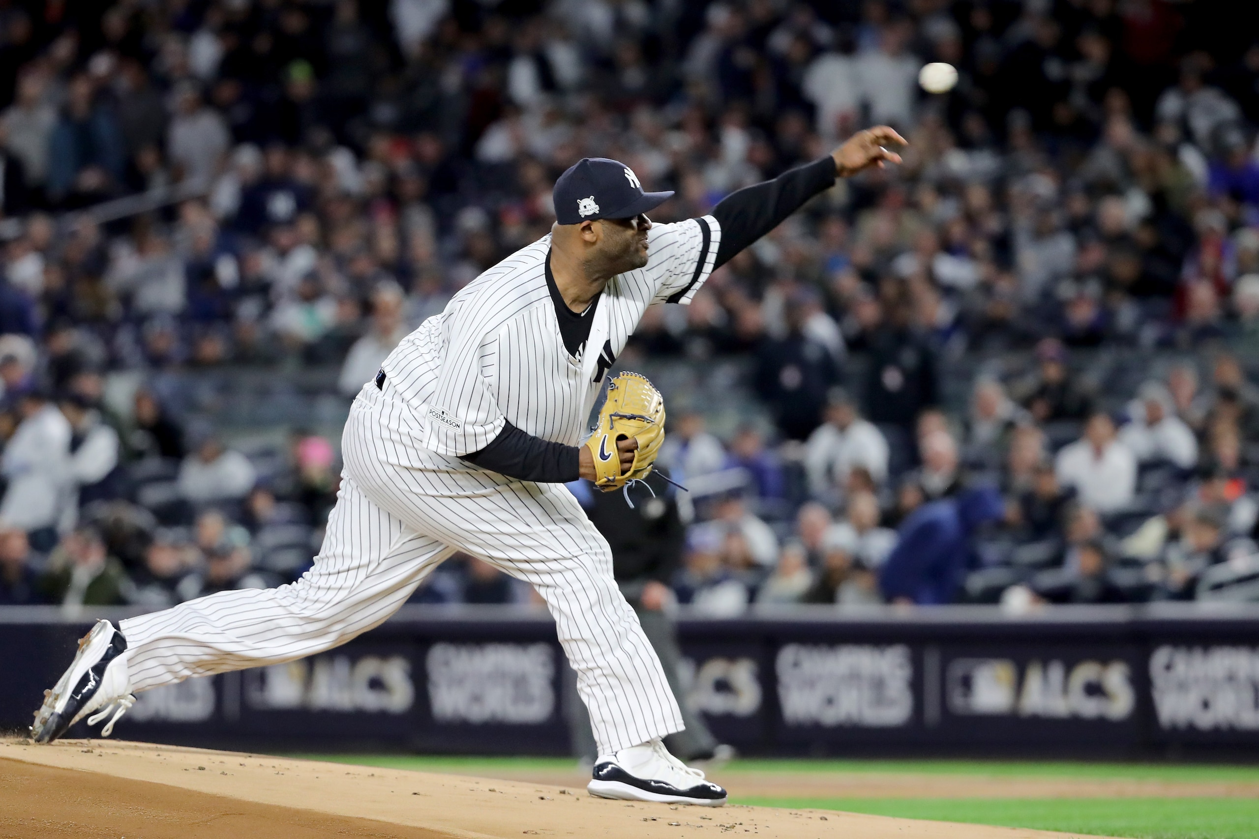 NEW YORK, NY - OCTOBER 16:  CC Sabathia #52 of the New York Yankees throws a pitch against the Houston Astros during the first inning in Game Three of the American League Championship Series at Yankee Stadium on October 16, 2017 in the Bronx borough of Ne