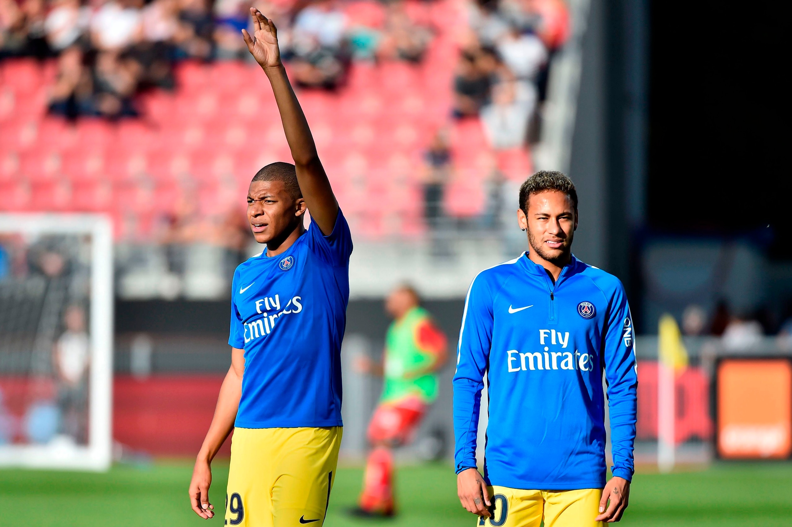 Paris' French forward Kylian Mbappe (L) gestures next to Paris' Brazilian forward Neymar (R) as they take part in a warm-up session prior to the French L1 football match between Dijon (DFCO) and Paris (PSG) on October 14, 2017, at the Gaston-Gerard stadiu