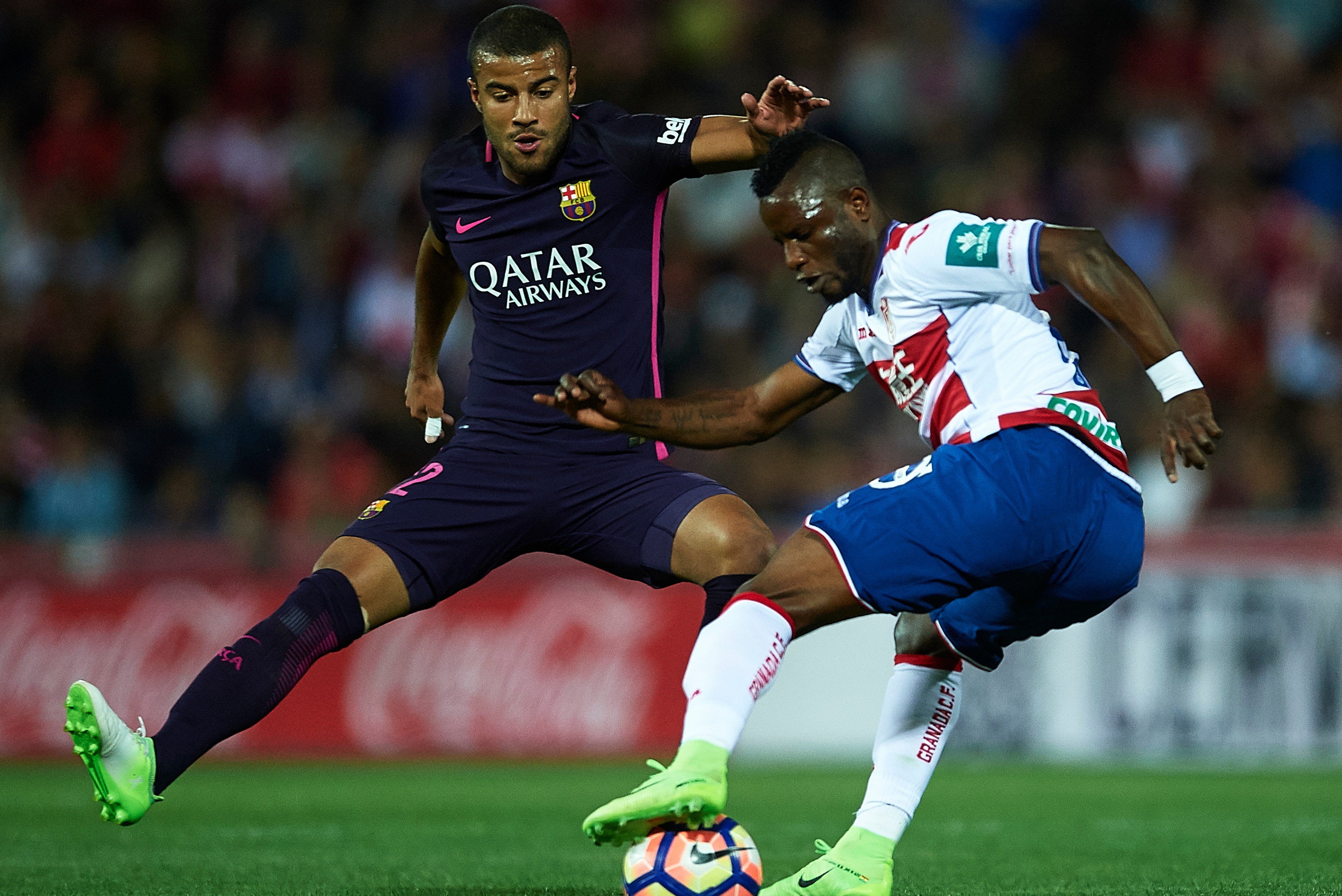 GRANADA, SPAIN - APRIL 02:  Uche Henry Agbo of Granada CF (R) being followed by Rafinha Alcantara of FC Barcelona (L) during the La Liga match between Granada CF v FC Barcelona at Estadio Nuevo Los Carmenes on April 02, 2017 in Granada, Spain.  (Photo by 