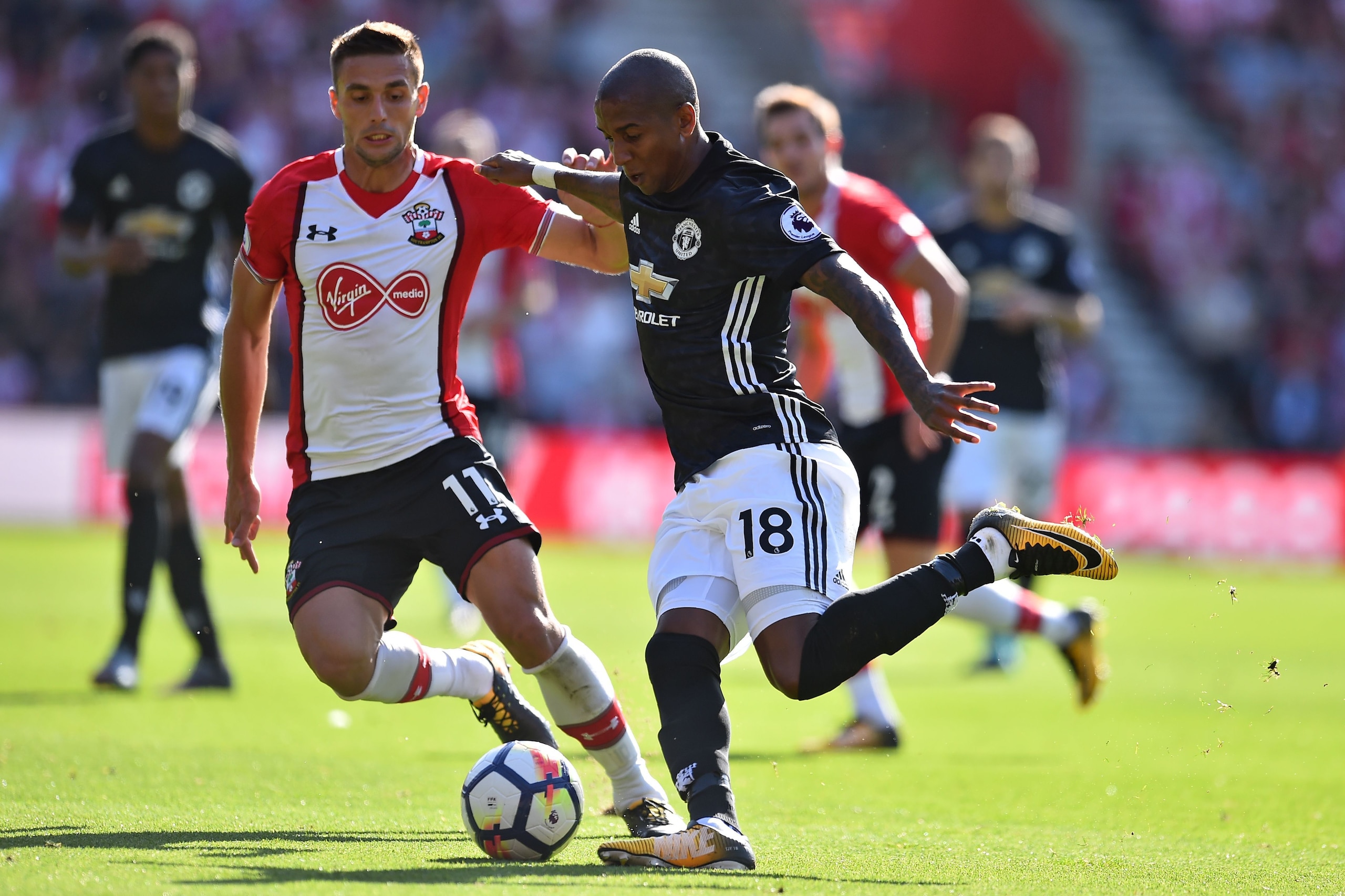 Manchester United's English midfielder Ashley Young (R) vies with Southampton's Serbian midfielder Dusan Tadic during the English Premier League football match between Southampton and Manchester United at St Mary's Stadium in Southampton, southern England