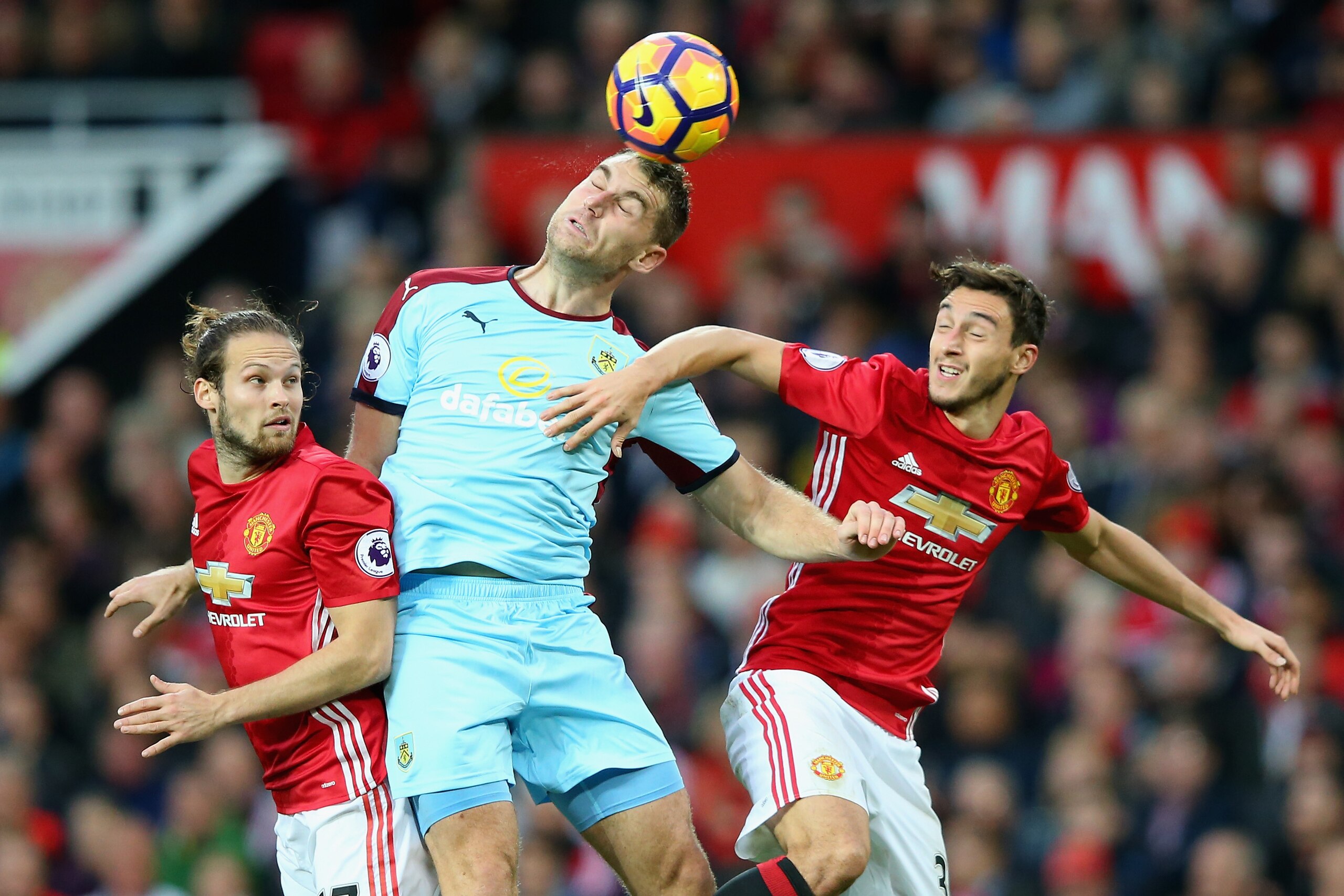 MANCHESTER, ENGLAND - OCTOBER 29: Scott Arfield (C) of Burnley competes against Daley Blind (L) and Matteo Darmian (R) of Manchester United during the Premier League match between Manchester United and Burnley at Old Trafford on October 29, 2016 in Manche