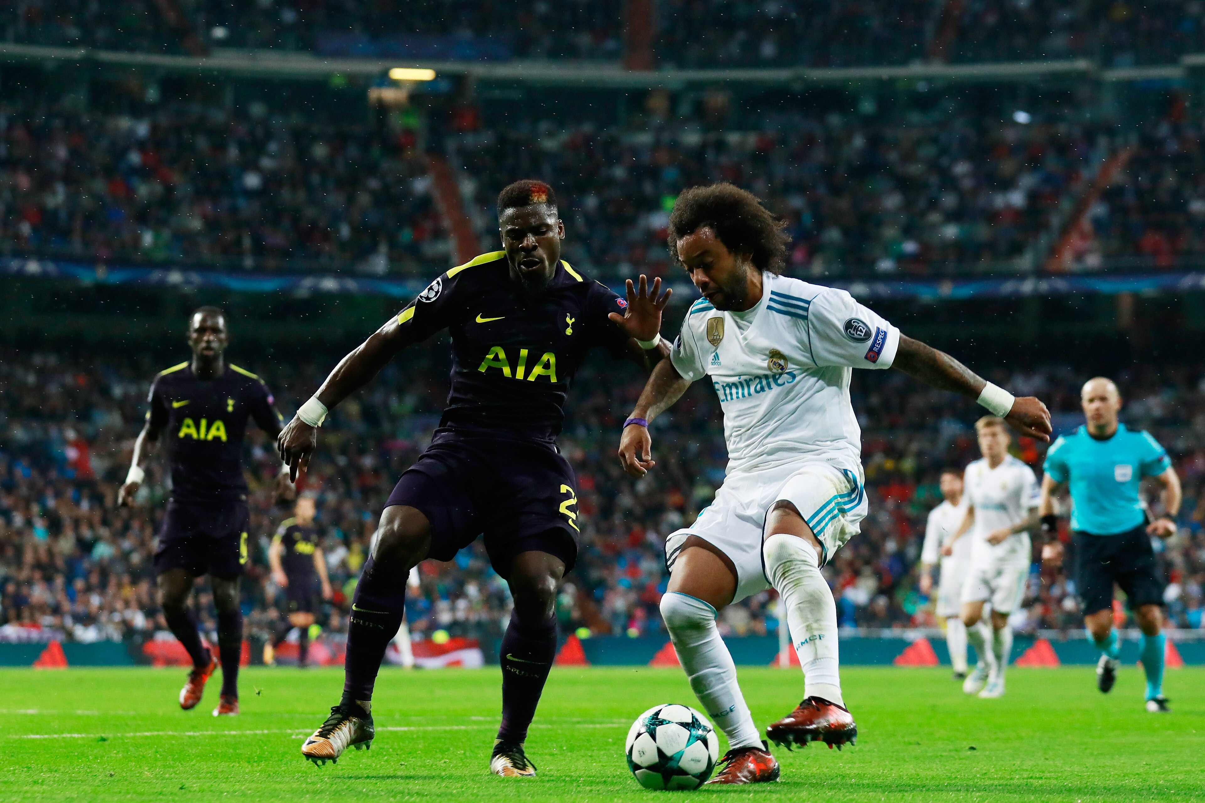 MADRID, SPAIN - OCTOBER 17: Serge Aurier of Tottenham Hotspur and Marcelo of Real Madrid battle for possession during the UEFA Champions League group H match between Real Madrid and Tottenham Hotspur at Estadio Santiago Bernabeu on October 17, 2017 in Mad