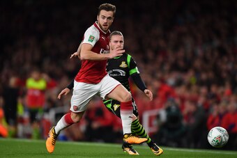 Arsenal's English defender Calum Chambers runs away from Doncaster Rovers' English striker Alfie May during the English League Cup third round football match between Arsenal and Doncaster Rovers at The Emirates Stadium in London on September 20, 2017. / A