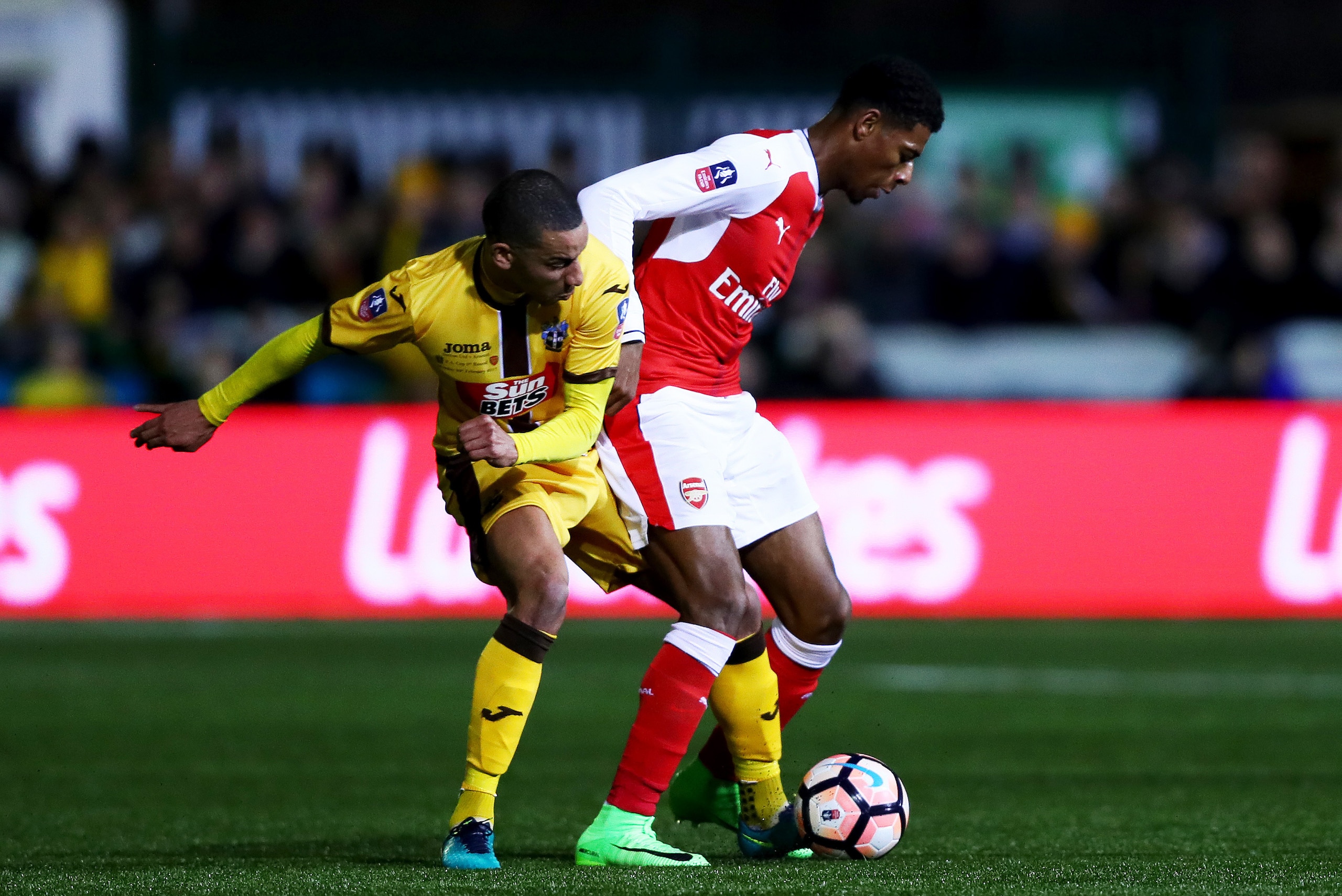 SUTTON, GREATER LONDON - FEBRUARY 20:  Jeff Reine-Adelaide of Arsenal battles for the ball with Craig Eastmond of Sutton United during the Emirates FA Cup fifth round match between Sutton United and Arsenal on February 20, 2017 in Sutton, Greater London. 