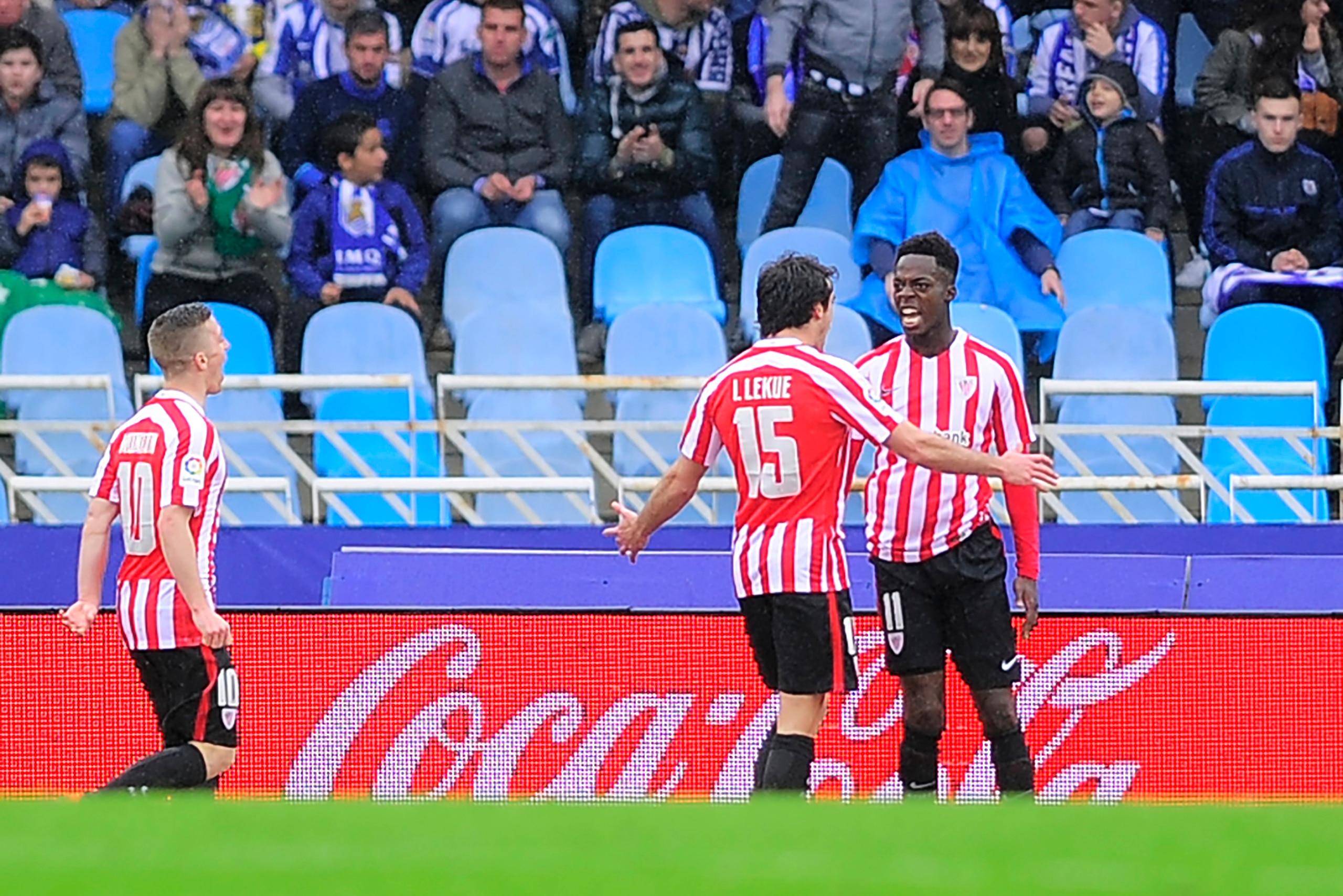 Athletic Bilbao's forward Inaki Williams Arthur (R) celebrates with teammate defender Inigo Lekue (C)  after scoring their team's second goal during the Spanish league football match Real Sociedad vs Athletic Club Bilbao at the Anoeta stadium in San Sebas