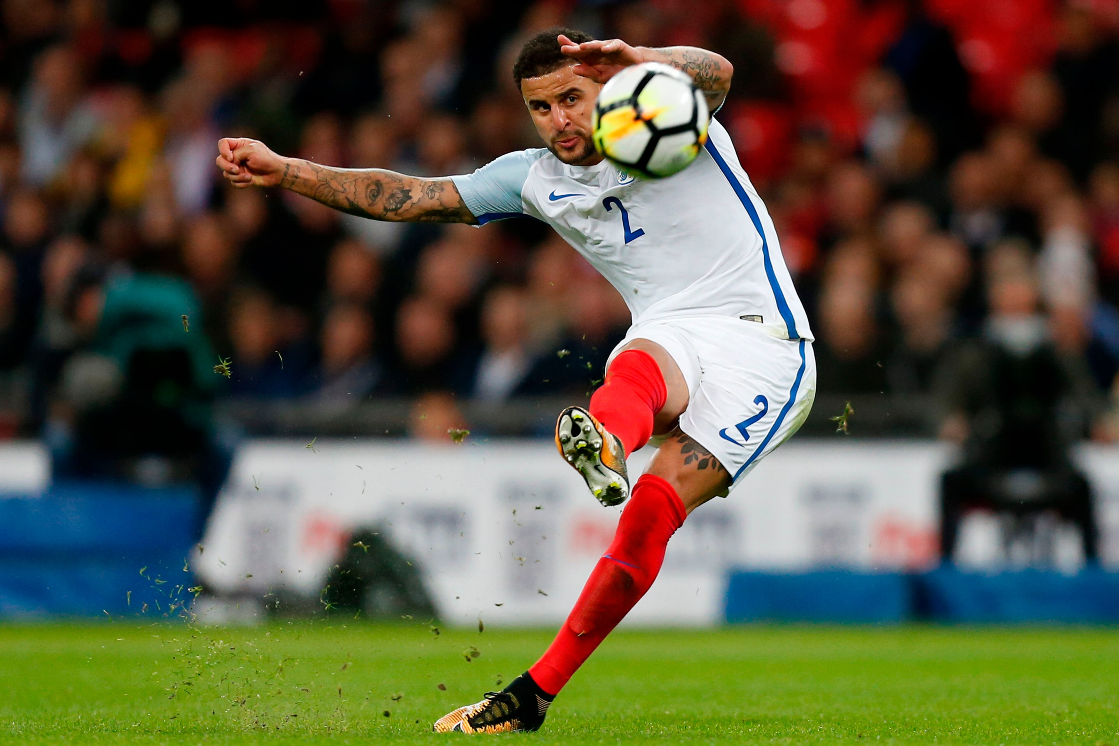 England's defender Kyle Walker takes a shot from a free kick during the FIFA World Cup 2018 qualification football match between England and Slovenia at Wembley Stadium in London on October 5, 2017. / AFP PHOTO / Ian KINGTON / NOT FOR MARKETING OR ADVERT England's defender Kyle Walker takes a shot from a free kick during the FIFA World Cup 2018 qualification football match between England and Slovenia at Wembley Stadium in London on October 5, 2017. / AFP PHOTO / Ian KINGTON / NOT FOR MARKETING OR ADVERT