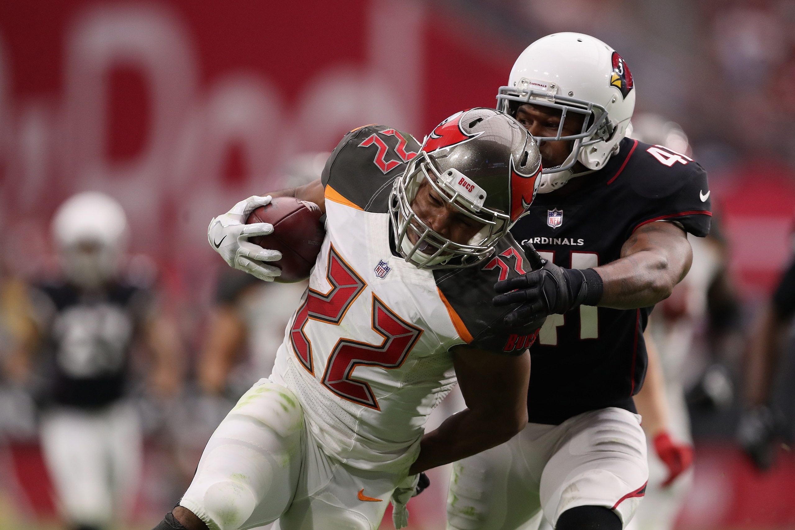 GLENDALE, AZ - OCTOBER 15:  Running back Doug Martin #22 of the Tampa Bay Buccaneers rushes the football past strong safety Antoine Bethea #41 of the Arizona Cardinals during the second half of the NFL game at the University of Phoenix Stadium on October 