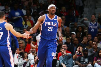WASHINGTON, DC -  OCTOBER 18:  Joel Embiid #21 of the Philadelphia 76ers gives a celebratory handshake to JJ Redick #17 of the Philadelphia 76ers during the 2017-18 regular season game against the Washington Wizards on October 18, 2017 at Capital One Aren