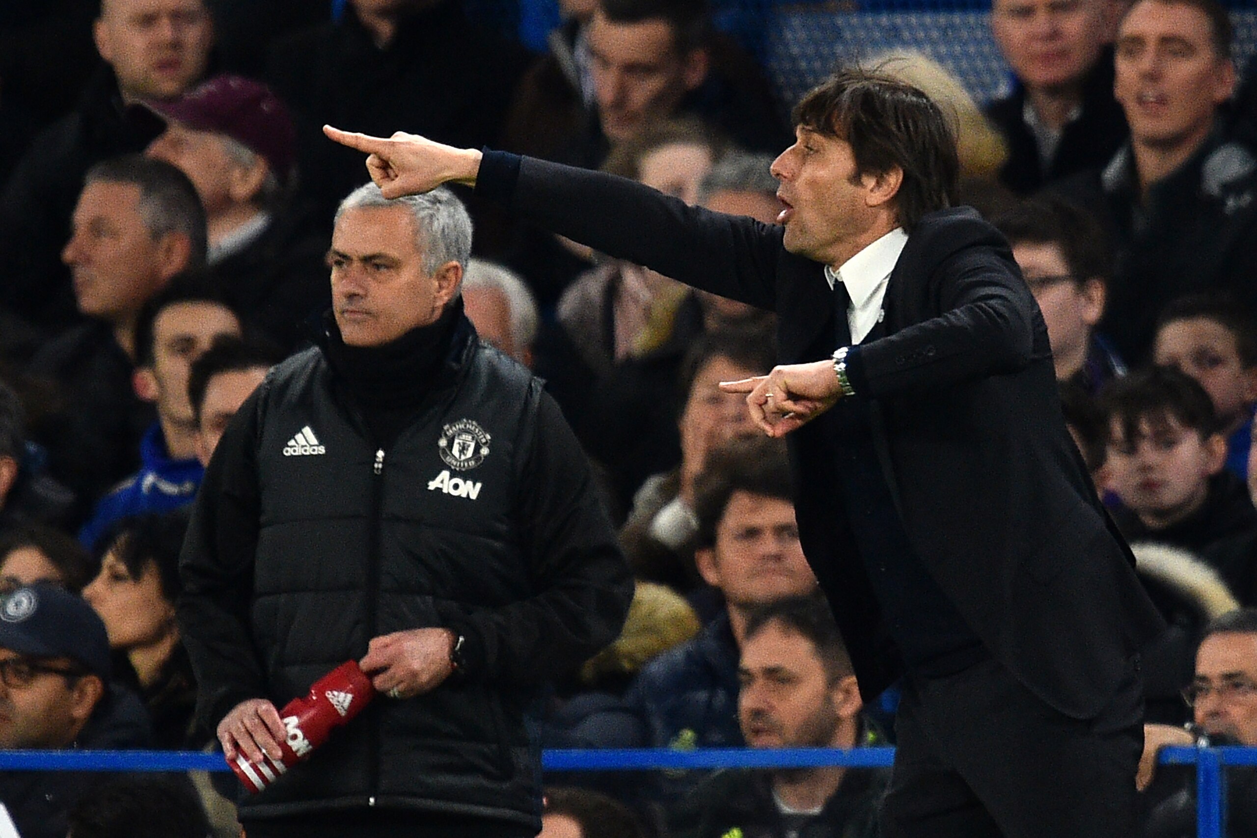 Chelsea's Italian head coach Antonio Conte (R) gestures on the touchline as Manchester United's Portuguese manager Jose Mourinho (L) looks on during the English FA Cup quarter final football match between Chelsea and Manchester United at Stamford Bridge i